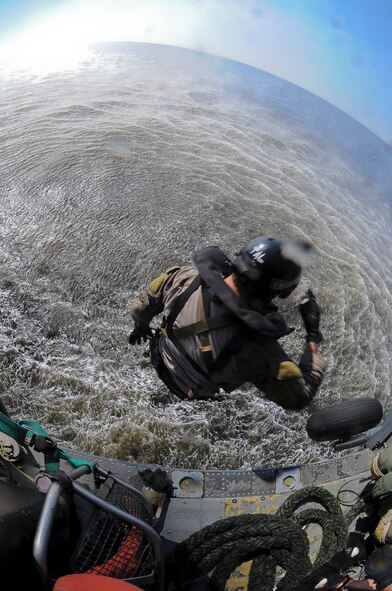 U.S. Air Force Staff Sgt. Justin Tyler, 38th Rescue Squadron pararescueman, freefalls from an HH-60G Pave Hawk into the Gulf of Mexico during water operations training, Oct. 11, 2012. The training allowed Tyler and Pave Hawk aircrew from the 41st Rescue Squadron to practice various rescue scenarios they might encounter in real-world situations. (U.S. Air Force photo by Staff Sgt. Joshua J. Garcia/Released)  