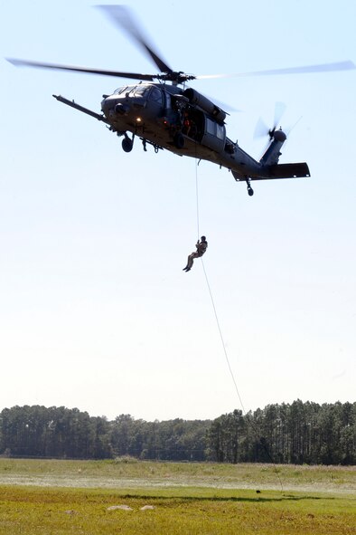 U.S. Air Force Staff Sgt. Justin Tyler, 38th Rescue Squadron pararescueman, rappels from an HH-60G Pave Hawk from the 41st Rescue Squadron during operations training near Moody Air Force Base, Ga., Oct. 11, 2012. Tyler practiced various maneuvers to descend from the aircraft during the training. (U.S. Air Force photo by Staff Sgt. Joshua J. Garcia/Released)  