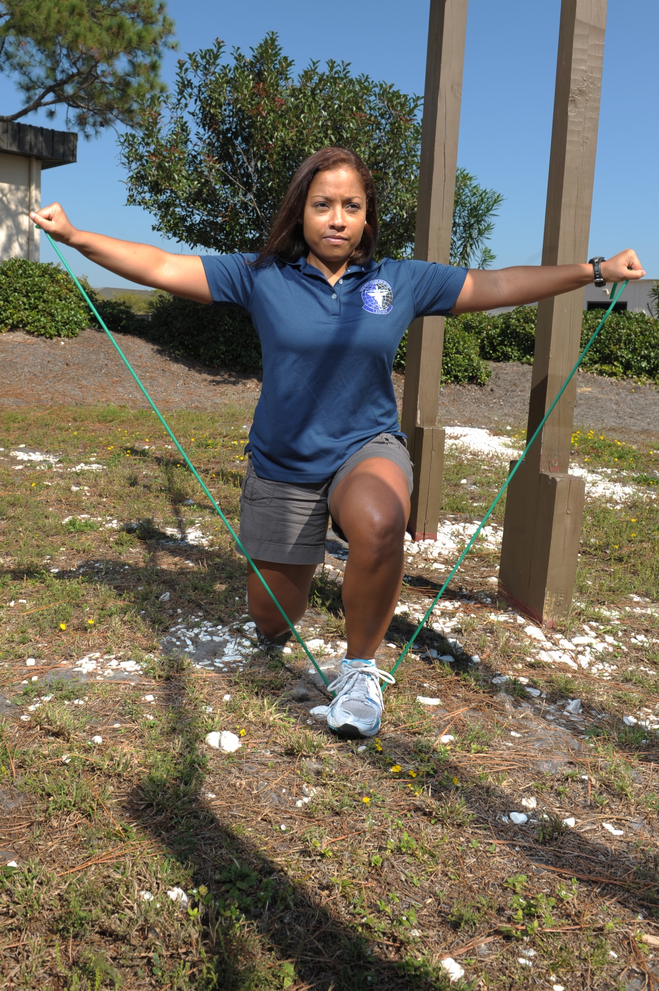 April Royster, Hurlburt Health and Wellness Center health and fitness specialist, demonstrates proper form for a lunge with the use a resistance band at the Commando Fitness Center at Hurlburt Field, Fla., Oct. 12, 2012. Royster instructs a high intensity and strength training post-pregnancy physical training class. (U.S. Air Force photo/Senior Airman Eboni Reams)
