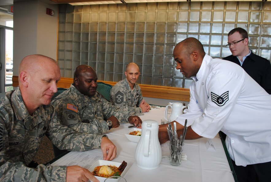 Staff Sgt. Breyson Robinson, 341st Force Support Squadron food service accountant, right, hands Command Sgt. Maj. Patrick Alston, U.S. Strategic Command senior enlisted leader, chili during the quarterly competition. (U.S. Air Force photo/Airman 1st Class Katrina Heikkinen)