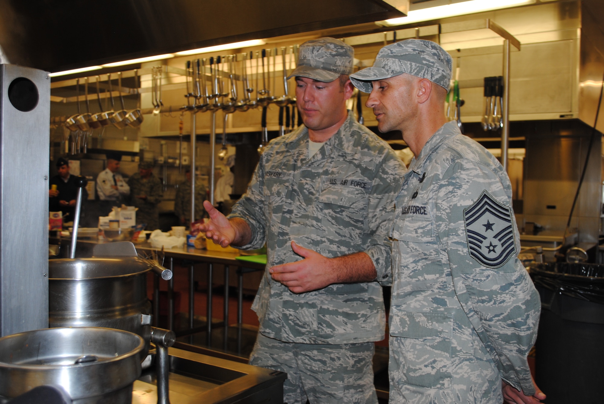 Tech. Sgt. Darnell Samuel, 819th RED HORSE Squadron NCO in charge of material control, and his teammate, Tech. Sgt. Cinnamon Calloway-Fuller, 819th RHS member, sauté onions as they prepare their signature dish of grilled butter spice chicken with pumpkin, mash potatoes and green beans. (U.S. Air Force photo/Airman 1st Class Katrina Heikkinen)