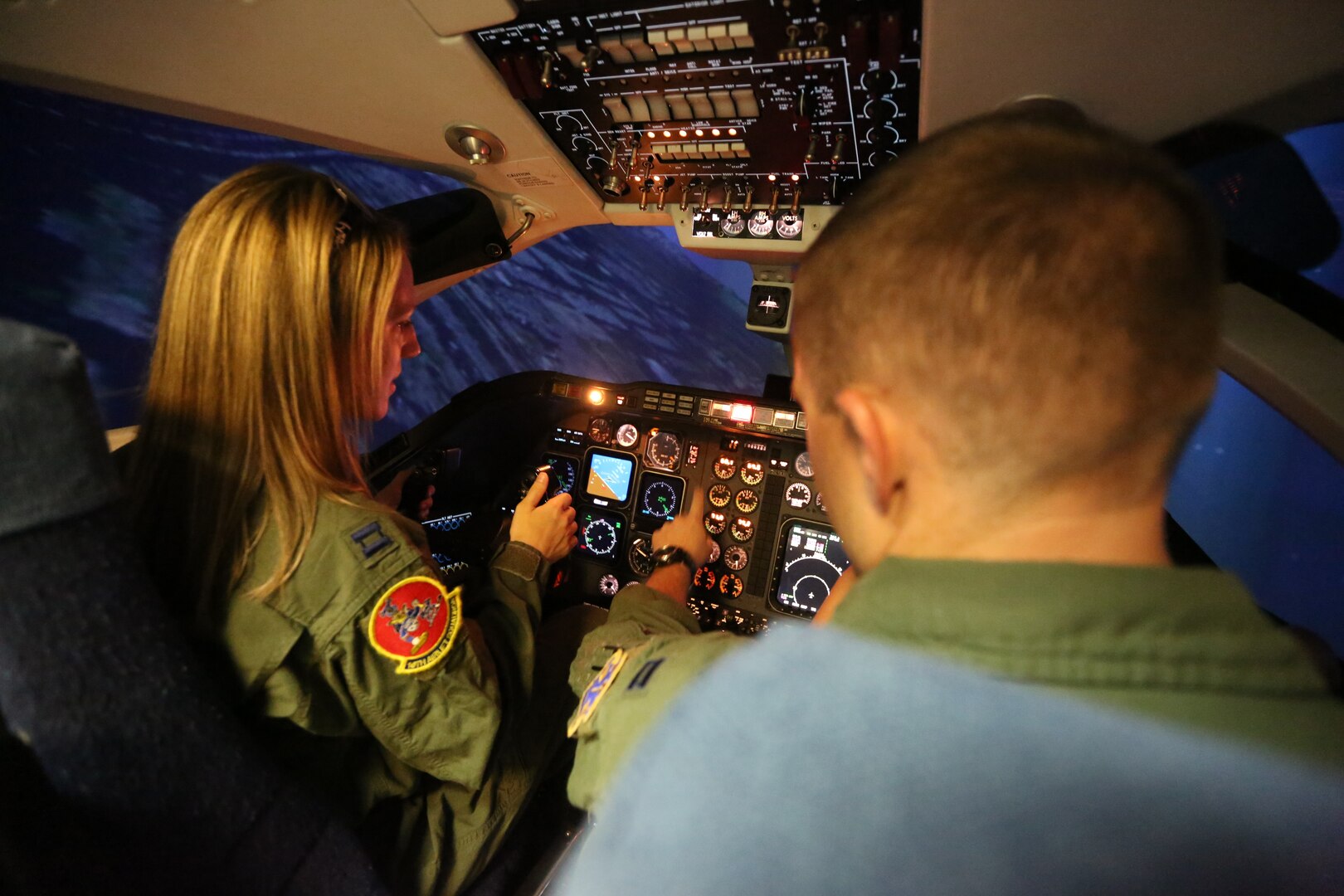 Capt. Cory Henwood, 99th Flying Training Squadron T-1A Jayhawk instructor training pilot, demonstrates to his wife, Rebekah Henwood, what it is like to fly in a simulator, during the 99th FTS Annual Spouse Appreciation day Oct 5. at Joint Base San Antonio-Randolph. Spouses who attended learned about their partner’s and other squadron members roles in the Air Force mission. (U.S. Air Force photo by Josh Rodriguez)