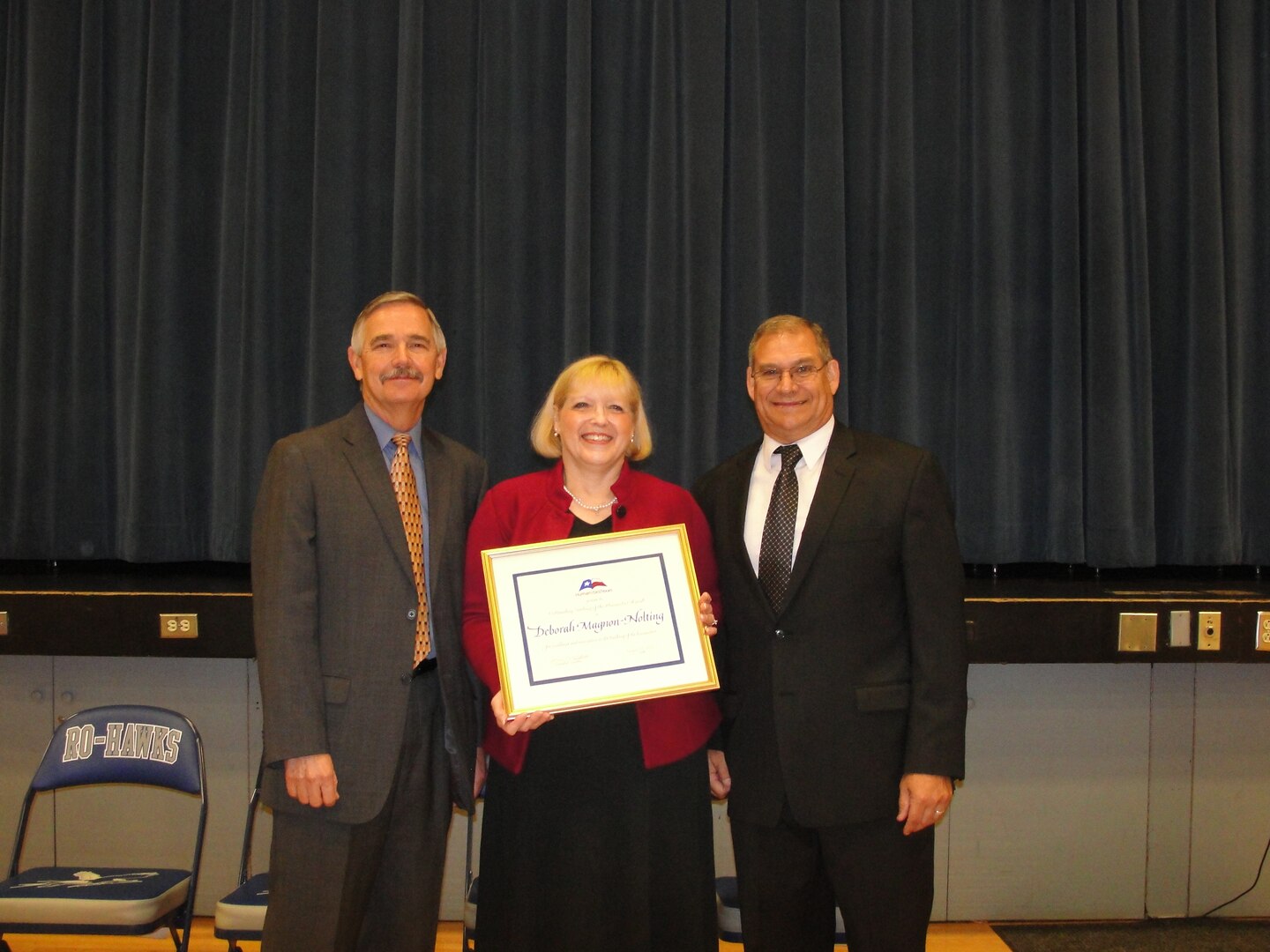 Billy Walker (left), Randolph Field Independent School District superintendent, and Miles Cabra (right), Randolph High School principal, congratulate Deborah Magnon-Nolting, Randolph High School teacher Oct. 17 after she received the Humanities Texas Outstanding Teaching of the Humanities Award and a $5,000 prize. (Courtesy photo)