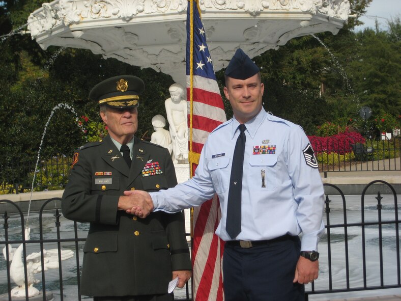 Following his re-enlistment ceremony, Kenneth shakes hands with his grandfather.  After finding out that retired commissioned officers from any branch of service could administer the oath of enlistment, Kenneth knew he would “have to ask him to do this at some point.”  Now, after his re-enlistment, Kenneth believes that “no decoration or award could have honored me more or taken the place of him doing this for me,” he said.  (U.S. Air Force Courtesy Photo)