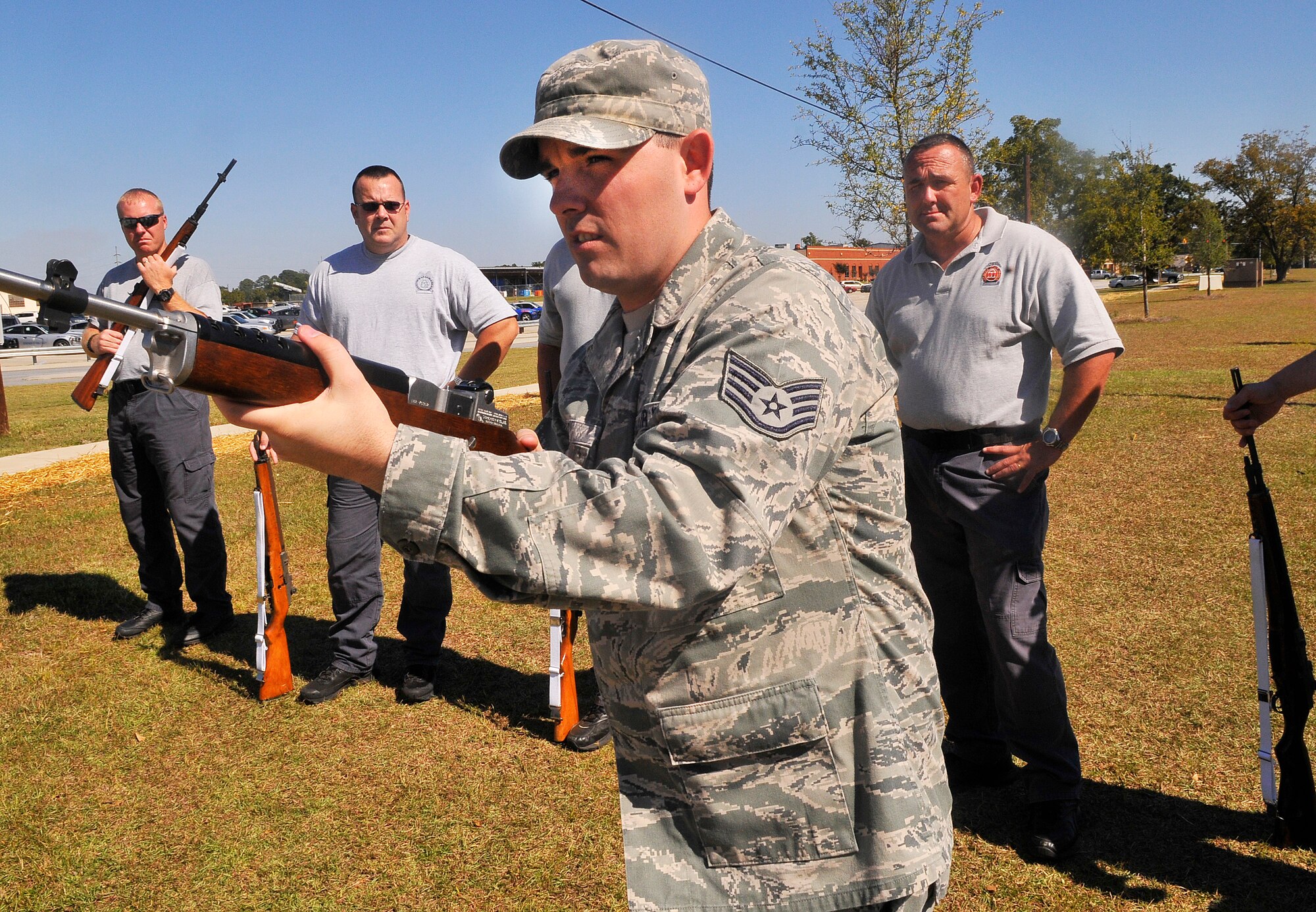 Staff Sgt. David Hart demonstrates a technique for Georgia State Patrolmen during firing party practice. Thirty One Georgia State Patrol honor guard members from around the state trained with the Robins Air Force Base Honor Guard Oct. 16-17. The GSP officers' goal was to improve techniques for their funeral and ceremonial services.(U. S. Air Force photo/Sue Sapp)