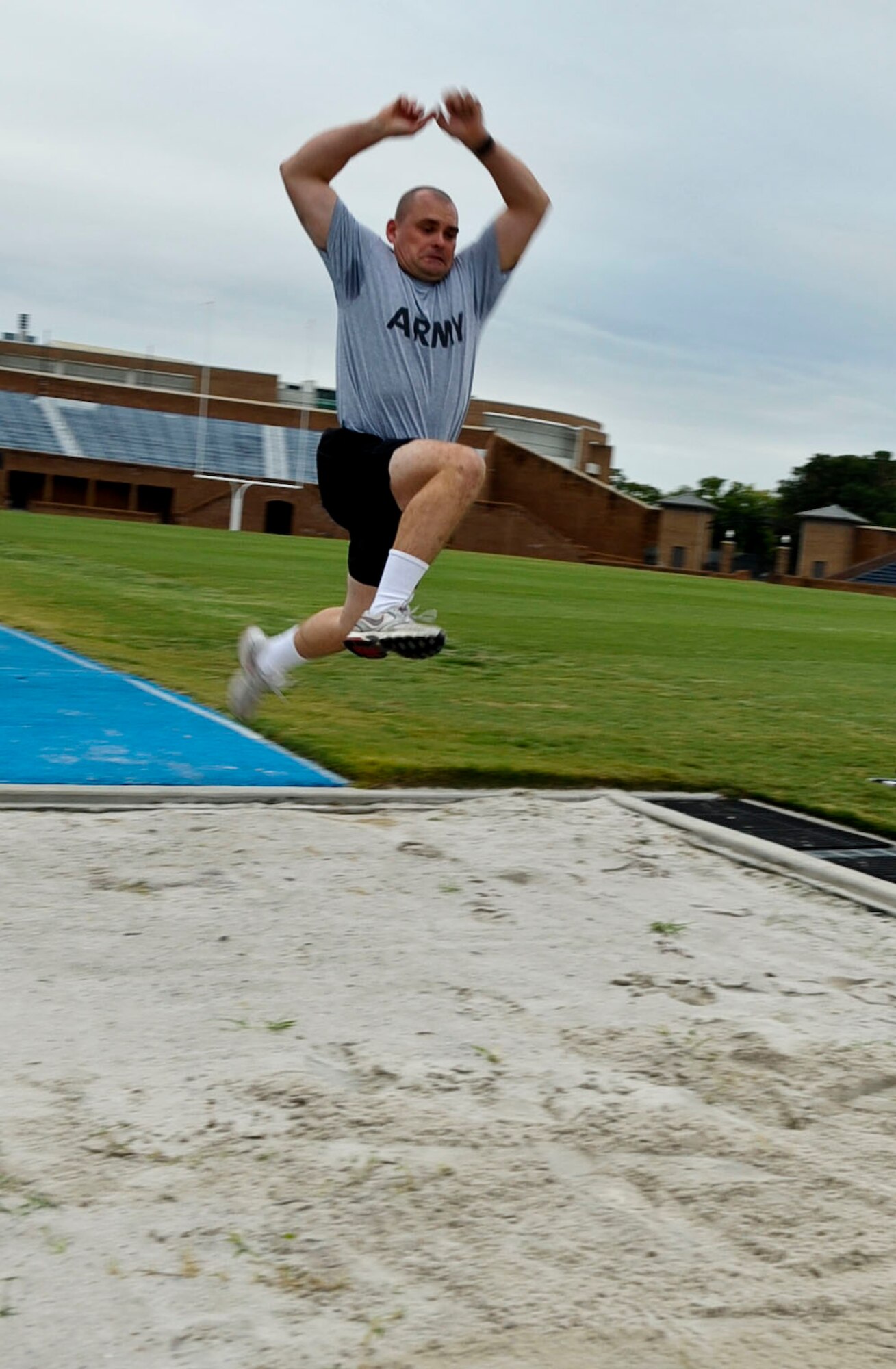 U.S. Army Spc. Krzysztof Slagowski, 359th Inland Cargo Transportation Company cargo specialist, completes a long jump during the German Armed Forces Badge for Proficiency competition at Hampton University in Hampton, Va., Sept. 19, 2012. Participants completed long jumps and high jumps, all part of a nearly two-week competition in order to qualify for the prestigious German military award. (U.S. Air Force photo by Staff Sgt. Wesley Farnsworth/Released)