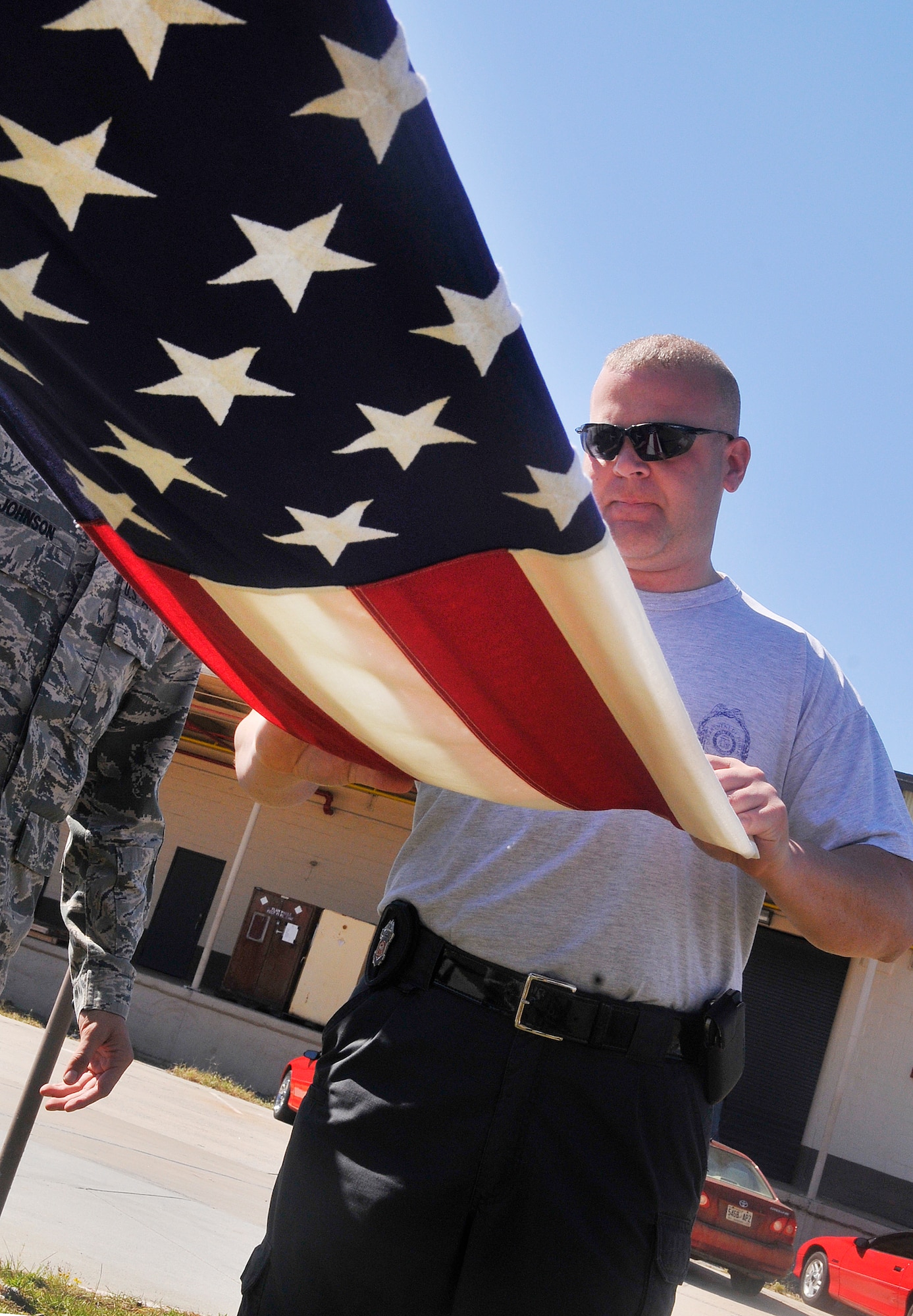 Andrew Montgomery, a Georgia State Patrol canine handler and honor guard member from Commerce, practices flag folding. Thirty One Georgia State Patrol honor guard members from around the state trained with the Robins Air Force Base Honor Guard Oct. 16-17.(U. S. Air Force photo/Sue Sapp)