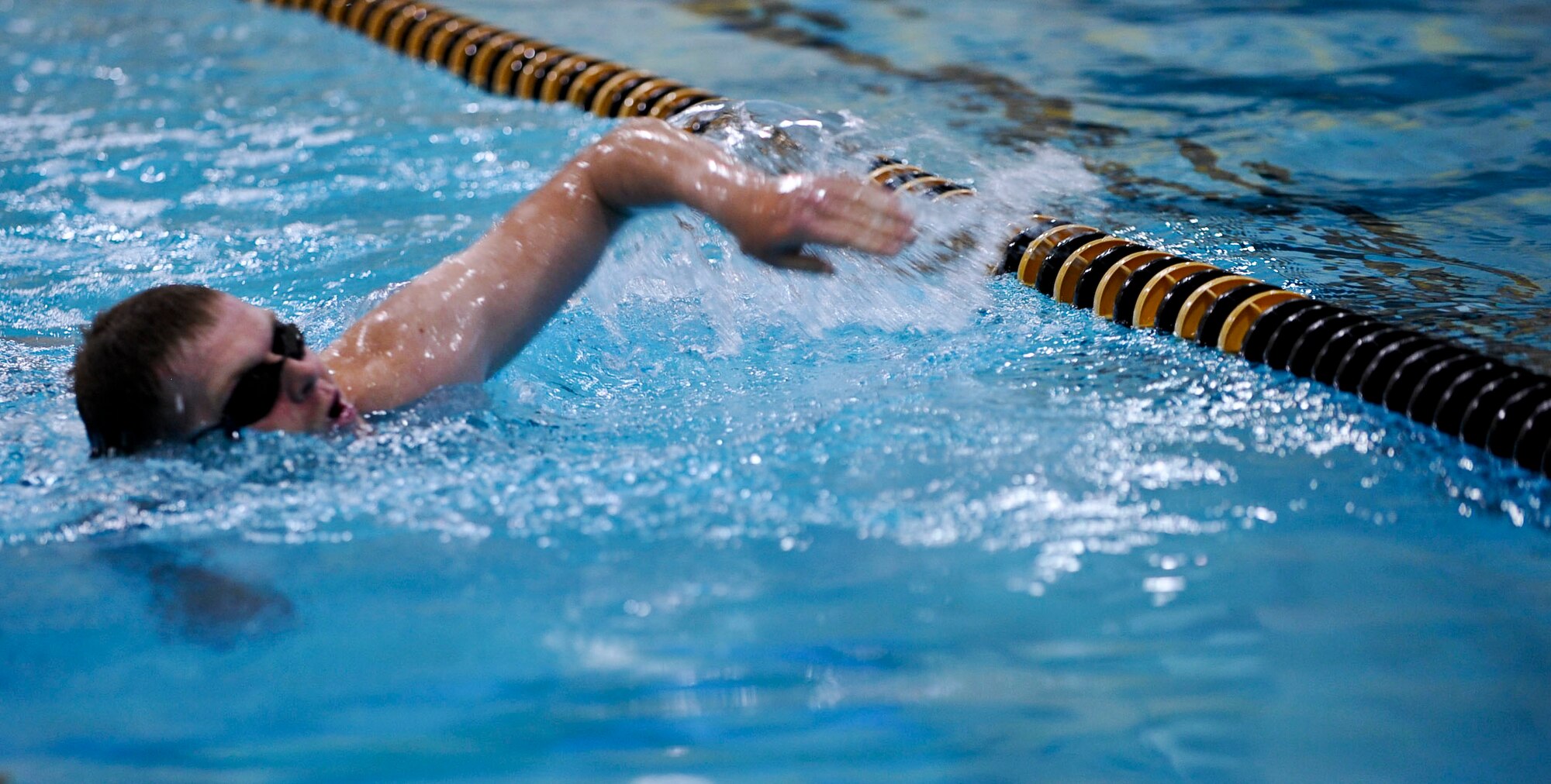 U.S. Army Spc. Chad Blizard, a Soldier assigned to the 359th Inland Cargo Transportation Company, completes the first of four laps during his 200 meter swim while attempting to earn the German Armed Forces Badge for Proficiency at Anderson Field House on Fort Eustis, Va., Sept. 18, 2012. To earn the badge, Service members must complete and qualify in a variety of events, including swimming, running, shot put throw, ruck march and pistol shooting. (U.S. Air Force photo by Staff Sgt. Wesley Farnsworth/Released)