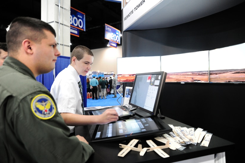 JOINT BASE ANDREWS, Md.- Staff Sgt. Jeffrey Grant, 779th Aerospace Medicine Squadron aerospace and operational physiology journeyman, and Daniel Steele, North Point High School student, explore remote technology at the Air Traffic Control Association's 57th Annual Conference Exposition at the Gaylord Convention center, National Harbor, Md., Oct. 3, 2012. Many exhibits demonstrated surveillance and information technology used in the aviation industry. (U.S. Air Force photo/ Senior Airman Amber Russell)