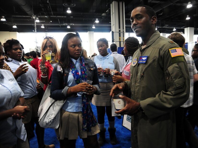 JOINT BASE ANDREWS, Md.- Maj. Jon-Michael, 99th Airlift Squadron pilot, Joint Base Andrews, mentors middle school students from Baltimore Rising Stars Academy during the Air Traffic Control Association's 57th Annual Conference Exposition at the Gaylord Convention center, National Harbor, Md., Oct. 3, 2012. Calhoun stressed the importance of math and science in is career field. (U.S. Air Force photo/ Senior Airman Amber Russell)
