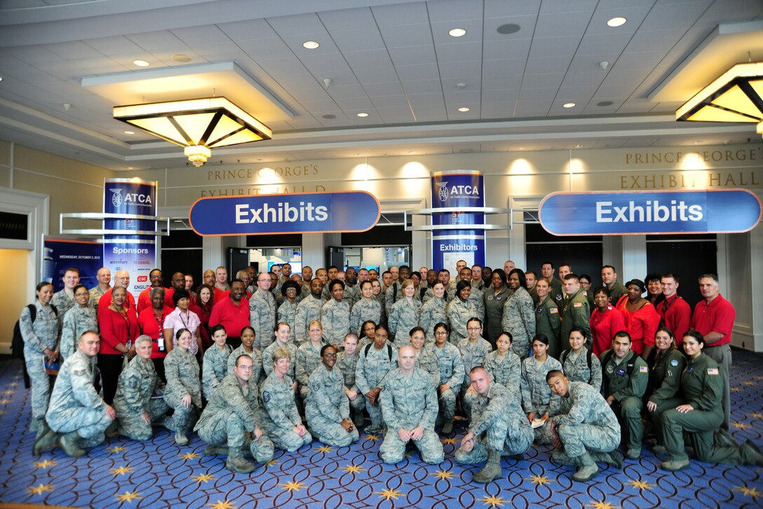 JOINT BASE ANDREWS, Md.- Airmen gather with members of the Federal Aviation Administration during the Air Traffic Control Association's 57th Annual Conference Exposition at the Gaylord Convention center, National Harbor, Md., Oct. 3, 2012. Service members and DoD employees from the National Capital Region volunteered chaperones for more than 1,000 students from 19 area schools. (U.S. Air Force photo/ Senior Airman Amber Russell)