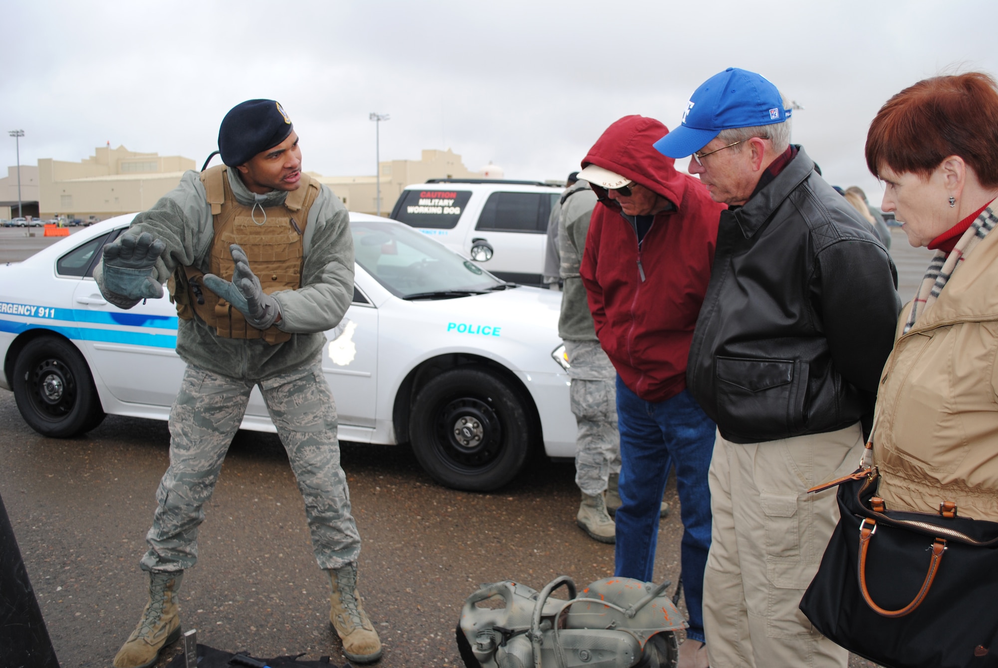 Airman 1st Class Nicholas Keyes, 341st Security Forces Group Tactical Response Force member, explains different breaching techniques and weapons used to gain entry of a building during a TRF tour on Oct. 11. Members on the Association of Air Force Missileers tour had a chance to watch a convoy ambush demonstration by the 341st Convoy Response Force, a static display of X-ray vehicles, Bearcats and a Humvee, and a canine demonstration. (U.S. Air Force photo/Airman 1st Class Katrina Heikkinen)