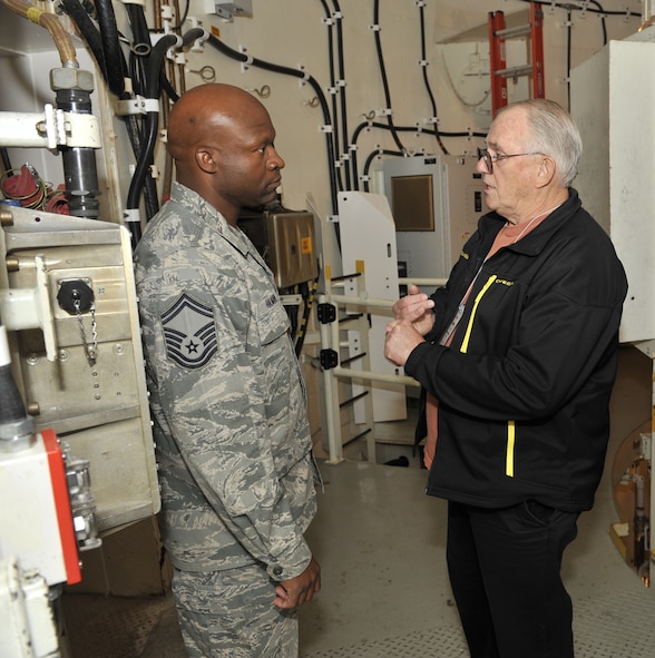 Senior Master Sgt. Dennis Halman, 341st Maintenance Operations Squadron training flight superintendant, talks with former missile maintainers retired Chief Master Sgt. Hank Habenick, assigned to the 341st Missile Wing from 1963-68 and again from 1971-79, during an Association of Air Force Missileers tour of the T-9 maintenance trainer Oct. 11.  (Air Force photo/ John Turner)