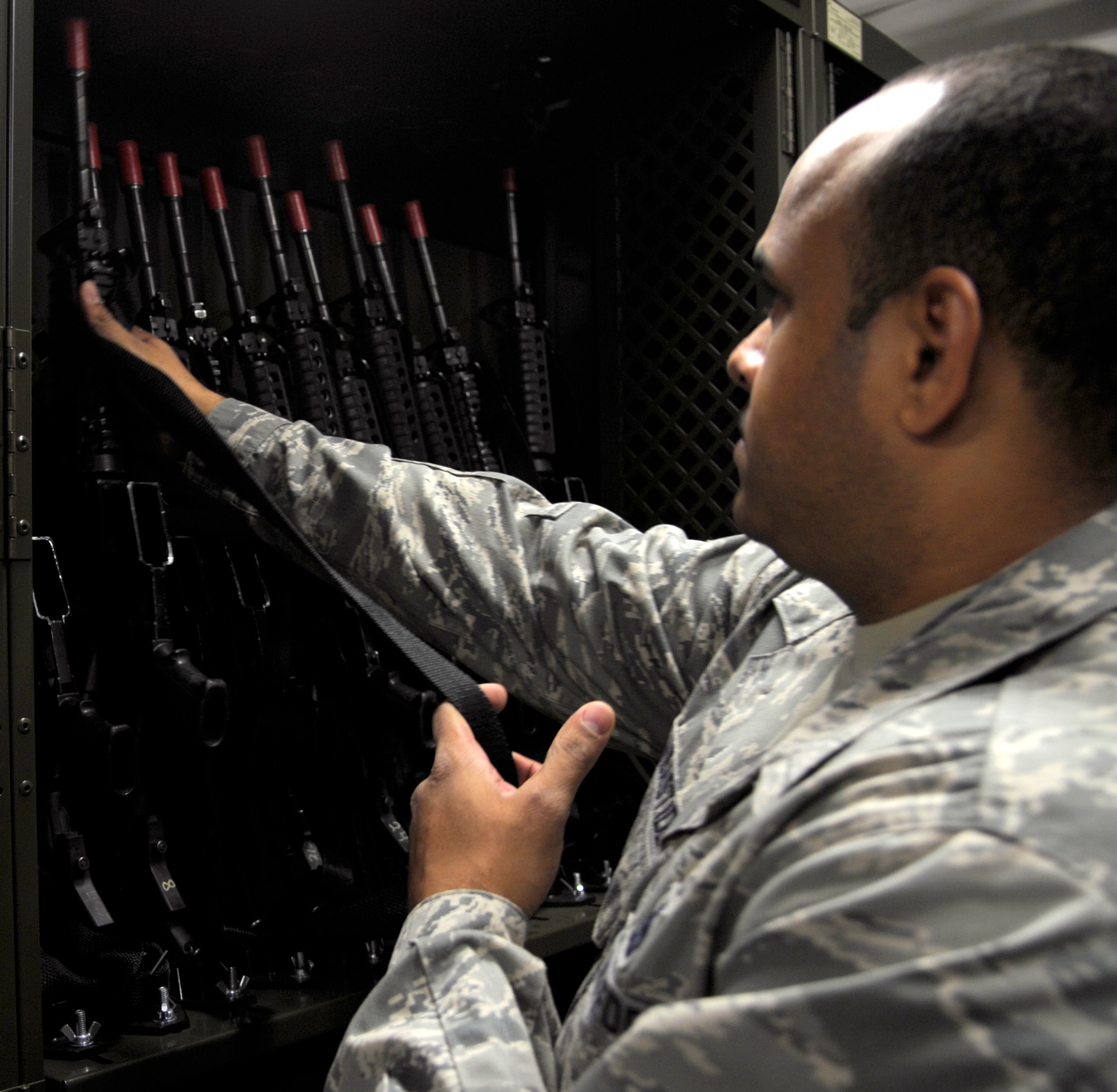 Staff Sgt. Ronald Delabastide, 509th Logistics Readiness Squadron weapons supervisor, returns an M-16 to its rack after practicing weapon deployment procedures at Whiteman Air Force Base, Mo., Oct. 15. The weapon rack is new to the 509th LRS and allows weapon handlers to deal with their inventory more efficiently. The rack is automatic and freed 900 square feet of room from the weapons vault. (U.S. Air Force photo/ Senior Airman Cody H. Ramirez)