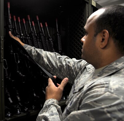 Staff Sgt. Ronald Delabastide, 509th Logistics Readiness Squadron weapons supervisor, returns an M-16 to its rack after practicing weapon deployment procedures at Whiteman Air Force Base, Mo., Oct. 15. The weapon rack is new to the 509th LRS and allows weapon handlers to deal with their inventory more efficiently. The rack is automatic and freed 900 square feet of room from the weapons vault. (U.S. Air Force photo/ Senior Airman Cody H. Ramirez)