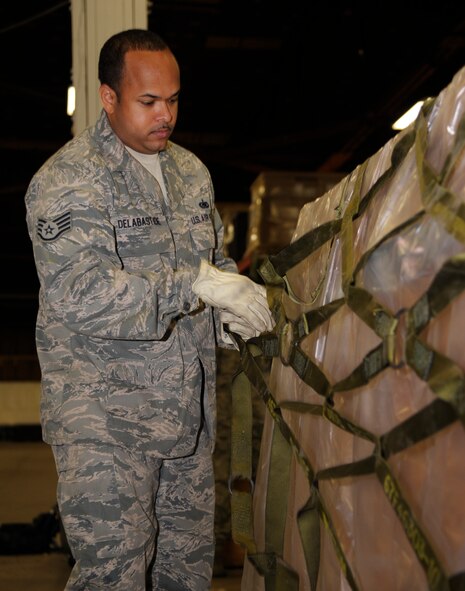 Staff Sgt. Ronald Delabastide, 509th Logistics Readiness Squadron weapons supervisor, secures a pallet full of B-bags Oct. 15 at Whiteman Air Force Base, Mo. The B-bags are full of cold weather gear, which was recently reviewed to ensure it was operationally functional. (U.S. Air Force photo/Senior Airman Cody H. Ramirez)