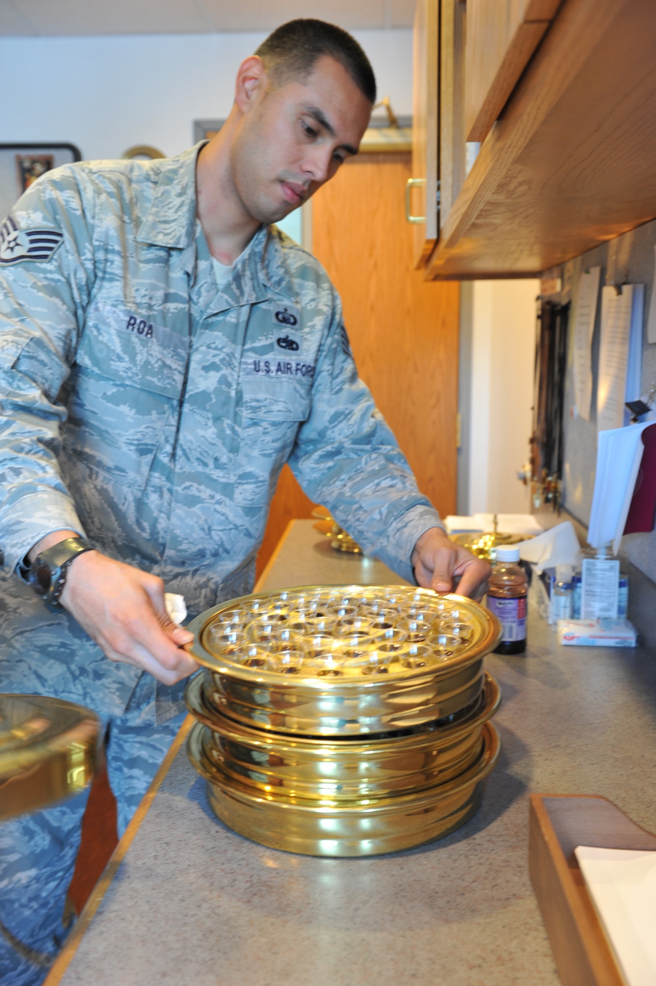 WHITEMAN AIR FORCE BASE, Mo. -- Staff Sgt. Benjamin Roa, 509th Bomb Wing chaplain assistant, prepares for communion prior to a Protestant worship service at the Whiteman Chapel Oct. 3. Chaplain assistants provide support of pastrol care and integrate spiritual advice to Team Whiteman. (U.S. Air Force photo/Heidi Hunt)