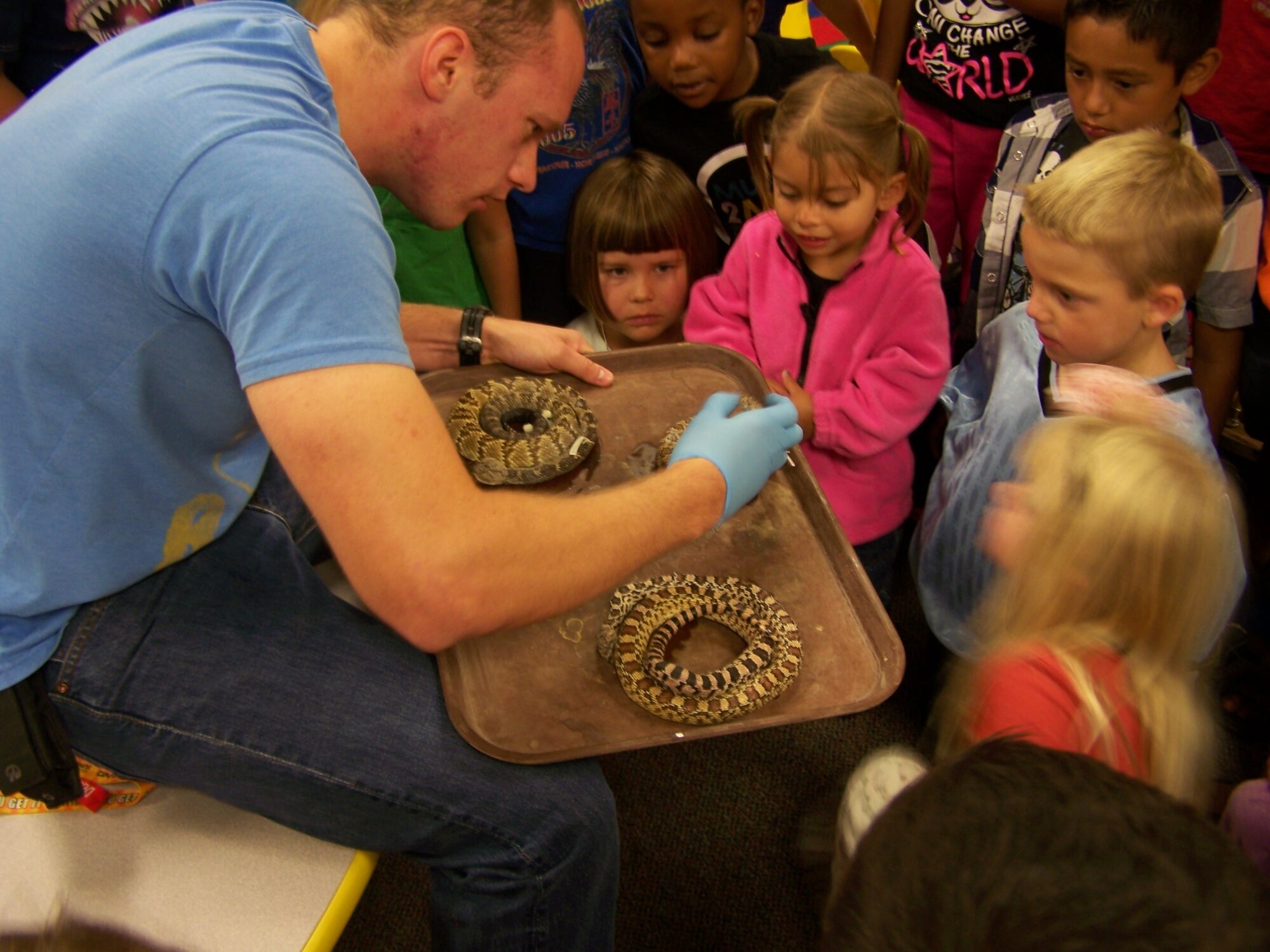 Dustin Akins displays the carcasses of a blacktail rattlesnake, a prairie rattlesnake and a bullsnake to children at the library during a presentation Sept. 15. Akins will present and answer questions about a variety of amphibians from 11 a.m. to noon Oct. 20 at the library.
