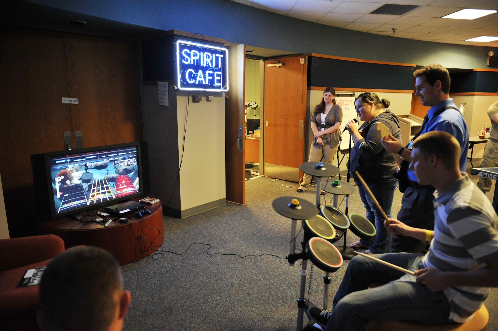WHITEMAN AIR FORCE BASE, Mo -- Members of Team Whiteman play a game of rock band at the Airman Ministry Center, better known as the Spirit Café Oct. 5. Managed by the Chaplain’s office, the café is free of charge and open to individuals age 18 and above, regardless of rank, marital status or religion. (U.S. Air Force photo/Heidi Hunt)