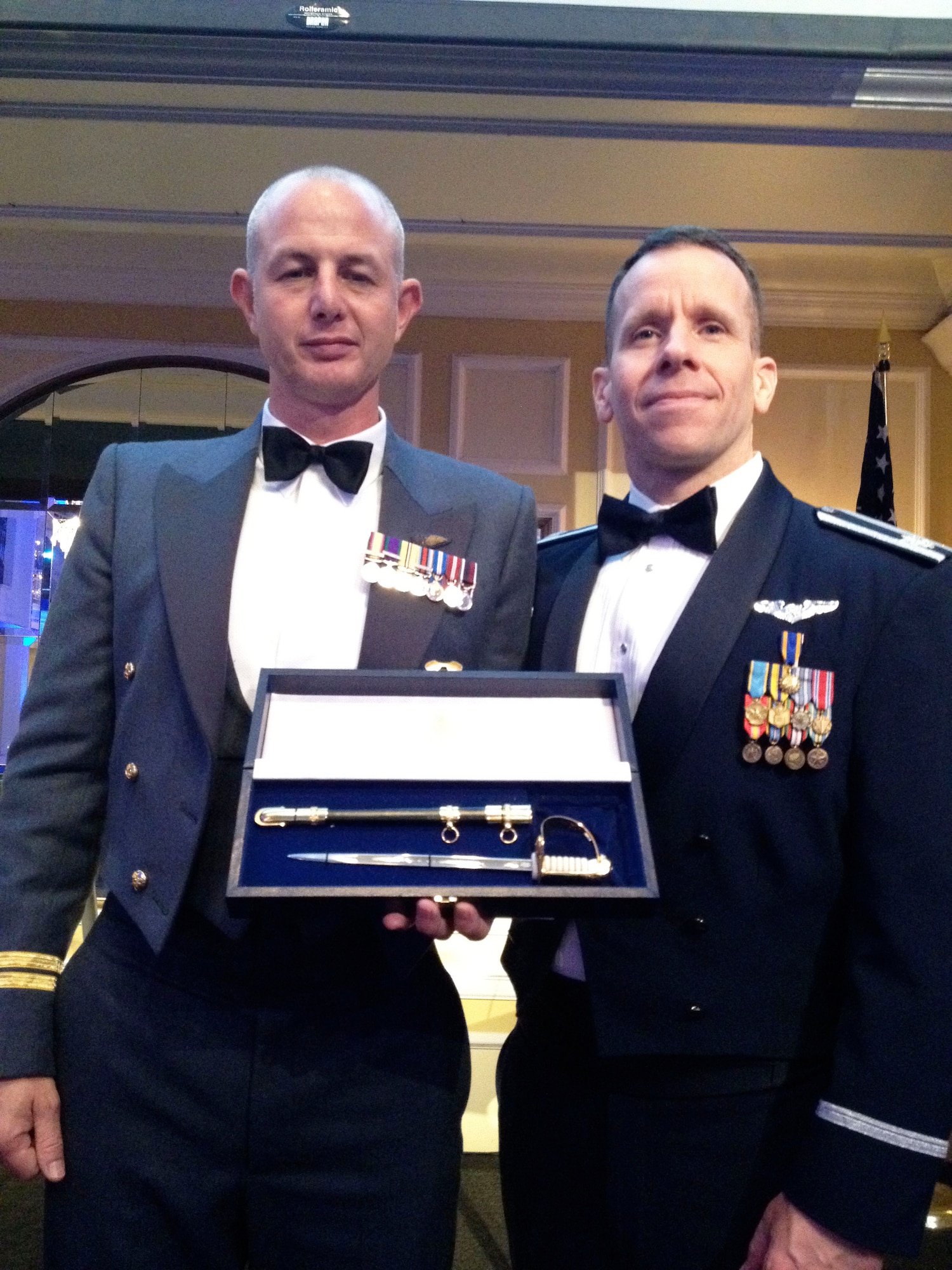 From left, Flt. Lt. Si Holden, a 16th Airborne Command and Control Squadron airborne  intelligence officer and instructor on the Joint Surveillance Target Attack Radar System, and Lt. Col. Paul Maykish, 16th ACCS commander pose with the 2012 Royal Air Force Sword of Honor following the 2012 Battle of Britain Gala Banquet in Washington D.C. Courtesy photo