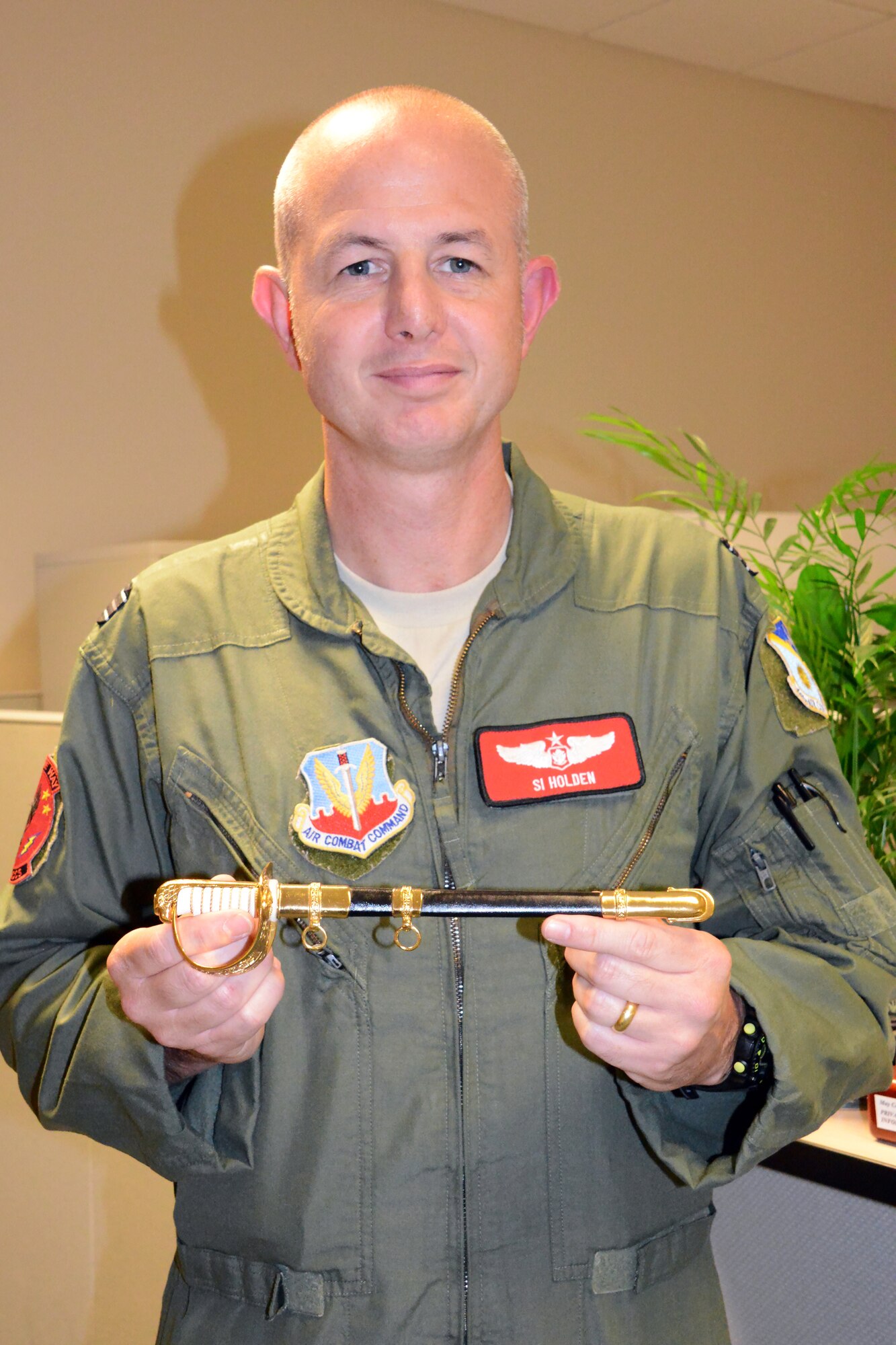 Flt. Lt. Si Holden was recently awarded the 2012 Royal Air Force Museum American Foundation RAF Sword of Honor. Above he displays the keepsake he received during an awards ceremony in Washington, D.C. (U. S. Air Force photo/Ed Aspera)