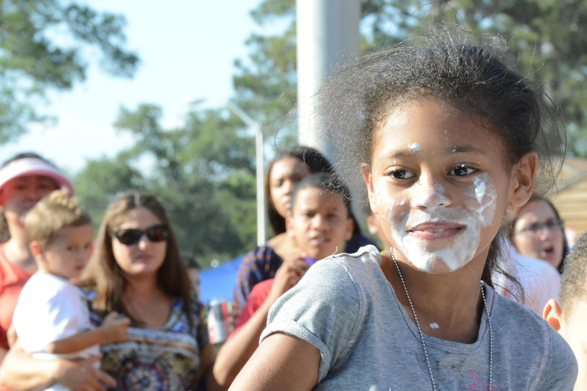 Mariyah King is all smiles after winning the pie-eating contest.(U. S. Air Force photo/Ed Aspera)