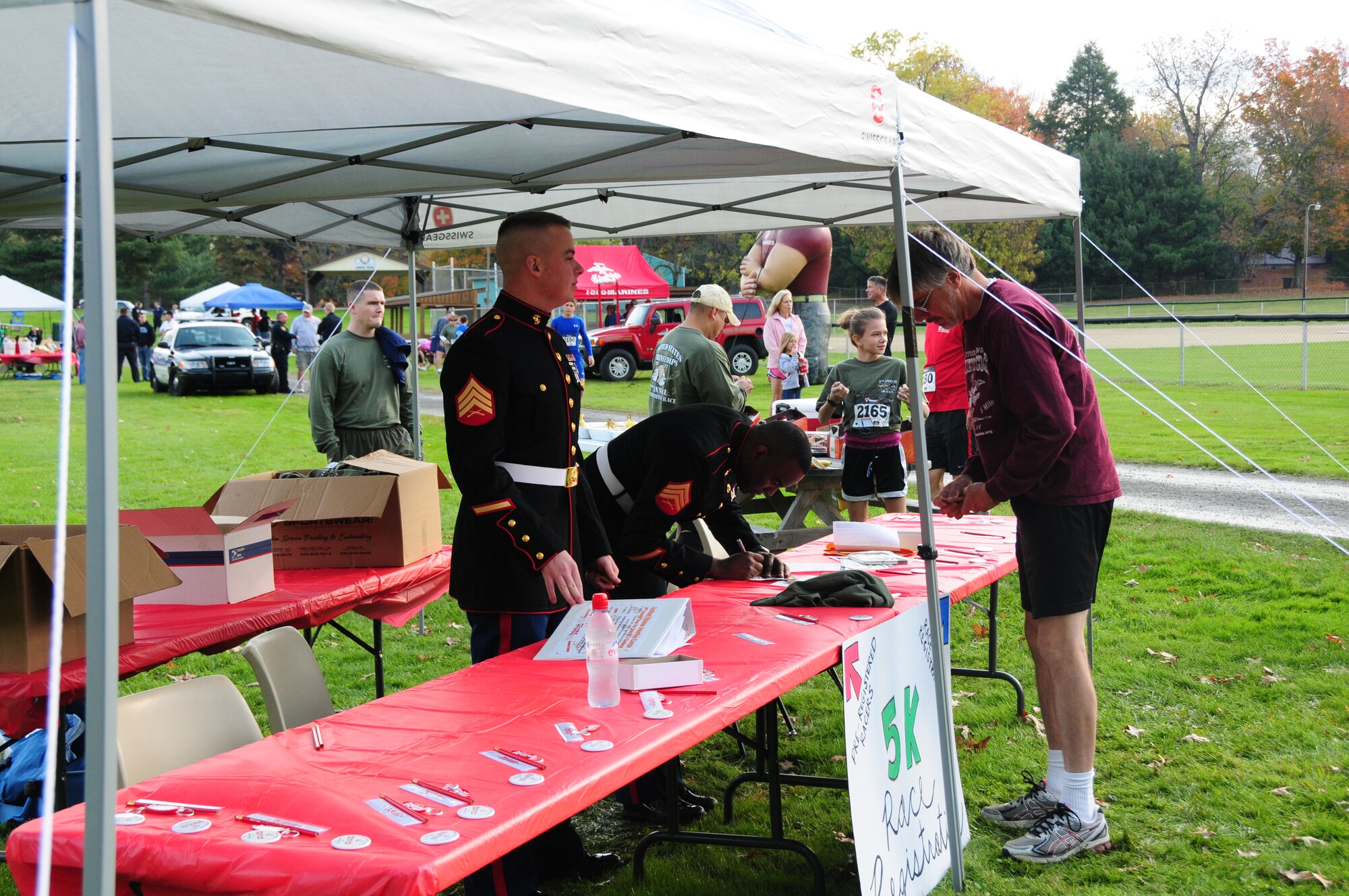 Marines from Youngstown Air Reserve Station’s Marine Corps Reserve Landing Support Equipment Company sign up runners for the second annual Toys for Tots fundraiser 5K race at Imagination Station Park in Cortland, Ohio, Oct. 14. The event kicked off the annual Toys for Tots campaign that exists to collect new unwrapped toys during October, November and December each year and distribute those toys as Christmas gifts to less fortunate children in the community in which the campaign is conducted. U.S. Air Force photo by Technical Sgt. Rick Lisum.