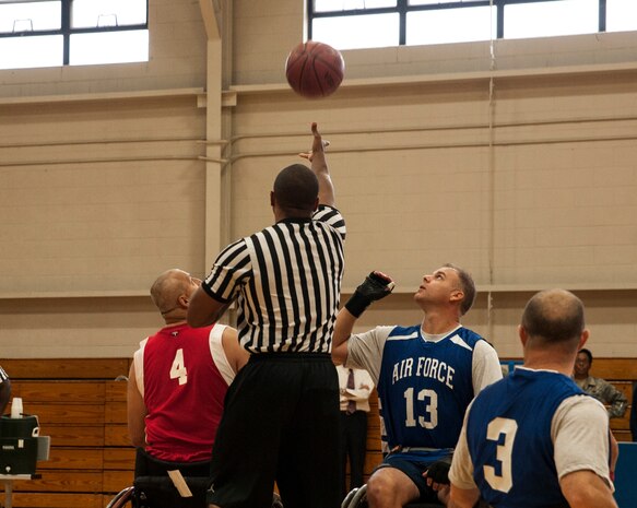 Master Sgt. James Kasch, 14th Airlift Squadron first sergeant, 437th Airlift Wing (right) and Senad Cerovic from the North Charleston Rolling Hurricanes (left) prepare for the tip-off during a wheelchair basketball game Oct. 17, 2012, at Joint Base Charleston - Air Base. The North Charleston Rolling Hurricanes are a wheelchair basketball team sponsored by the Achieving Wheelchair Equality. AWE is dedicated to encouraging people with mobility impairments to participate in recreational activities. (U.S. Air Force photo/Airman 1st Class Ashlee Galloway)