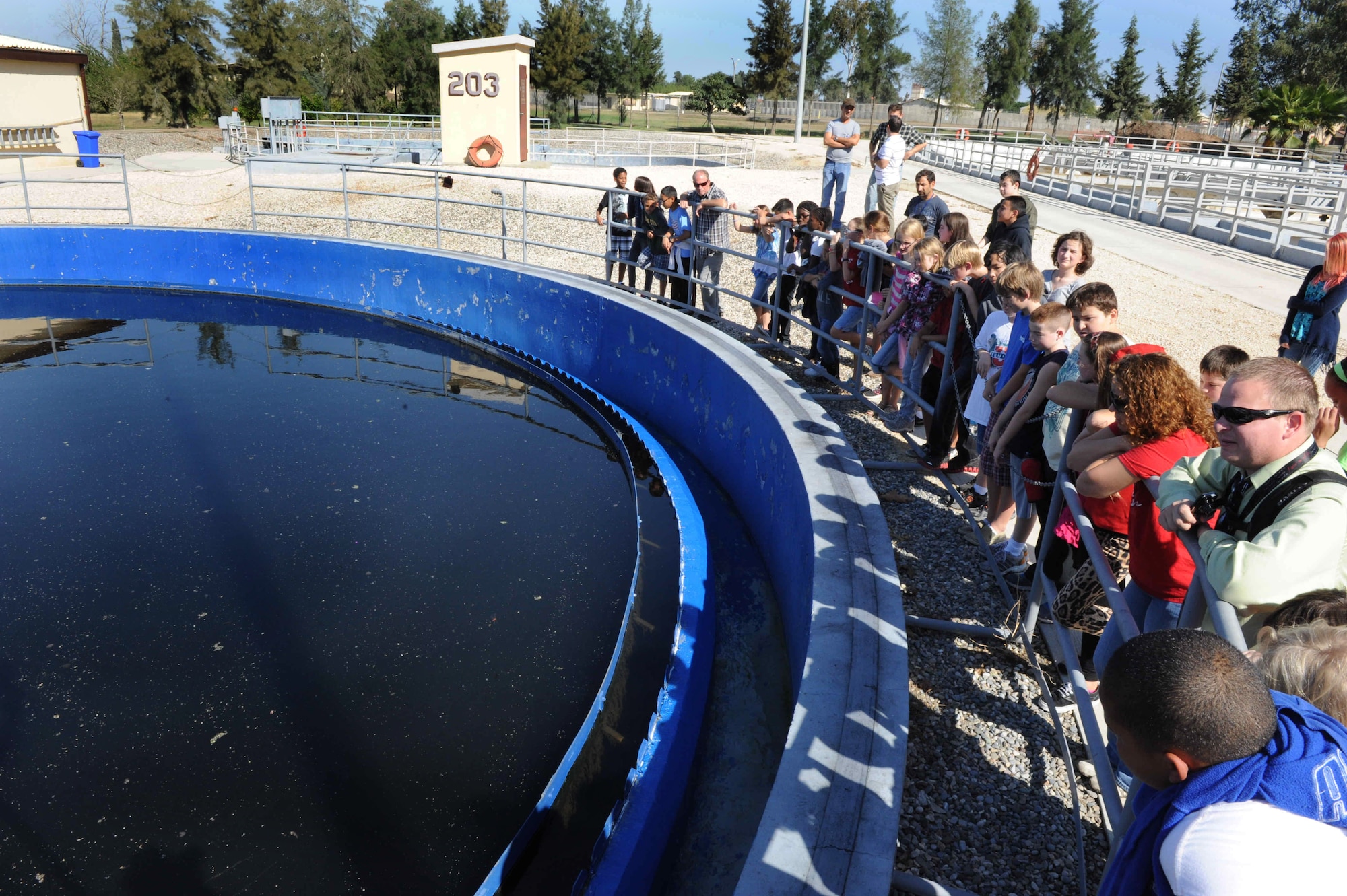 Sixth and seventh-graders learn the different steps in how waste is processed at the waste-water treatment facility Oct. 16, 2012, at Incirlik Air Base, Turkey. The tanks are used to clean the water and can contain around 300,000 gallons. (U.S. Air Force photo by Senior Airman Anthony Sanchelli/Released)
