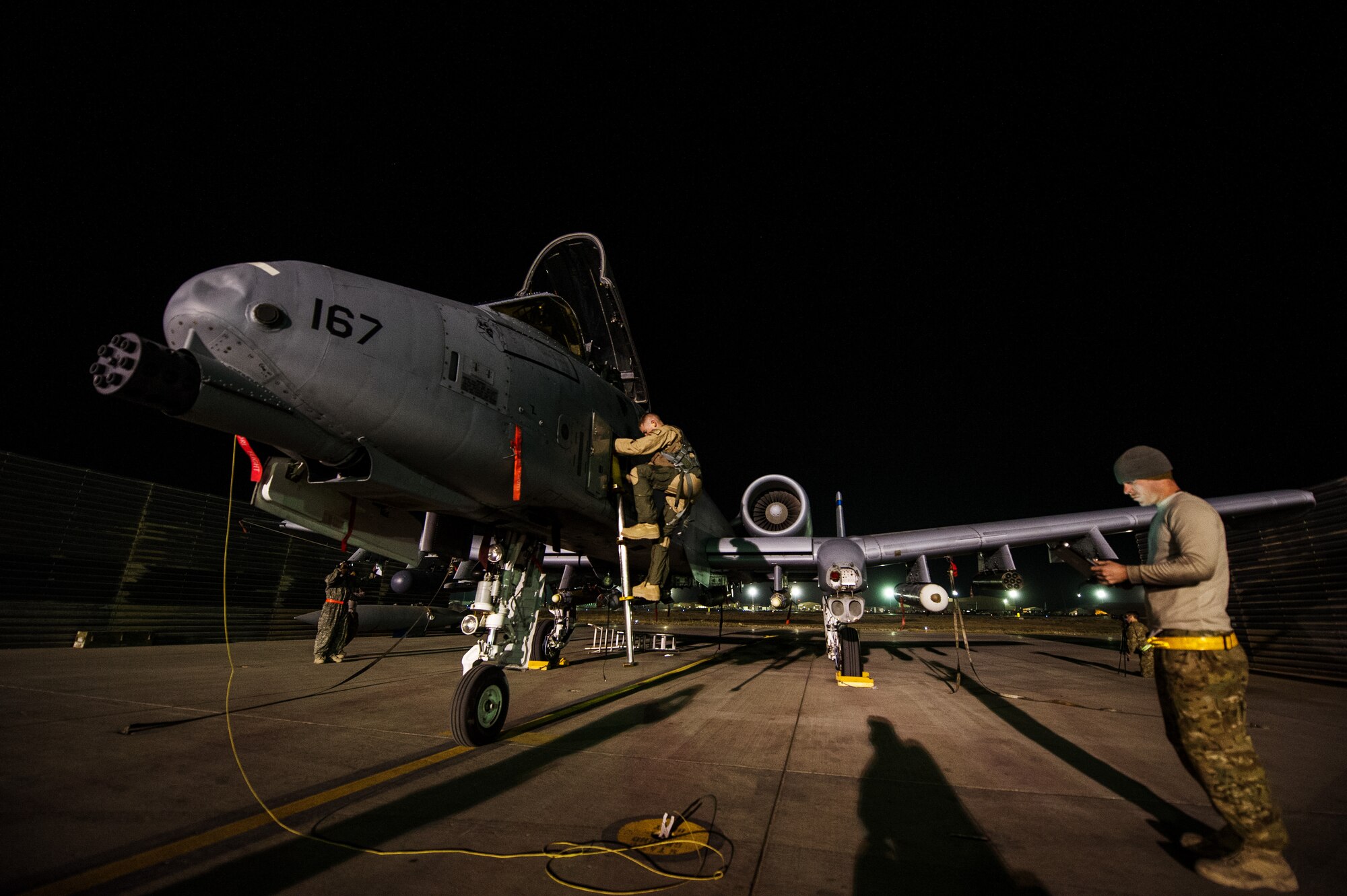 Capt. Kevin Belcher, 354th Expeditionary Fighter Squadron, climbs down from an A-10 Thunderbolt II after completing a combat sortie while SSgt Chris Loder, 455th Expeditionary Aircraft Maintenance Squadron, dedicated crew chief, reviews technical orders on Oct. 16, 2012, Bagram Airfield, Afghanistan. Bagram’s A-10s fly daily to provide constant close-air support to NATO and Afghan ground forces operating in Afghanistan. Belcher hometown is Southington, Ky. and Loder hometown is Clarksville, Tenn. (U.S. Air Force photo/ Staff Sgt. Jonathan Snyder) 