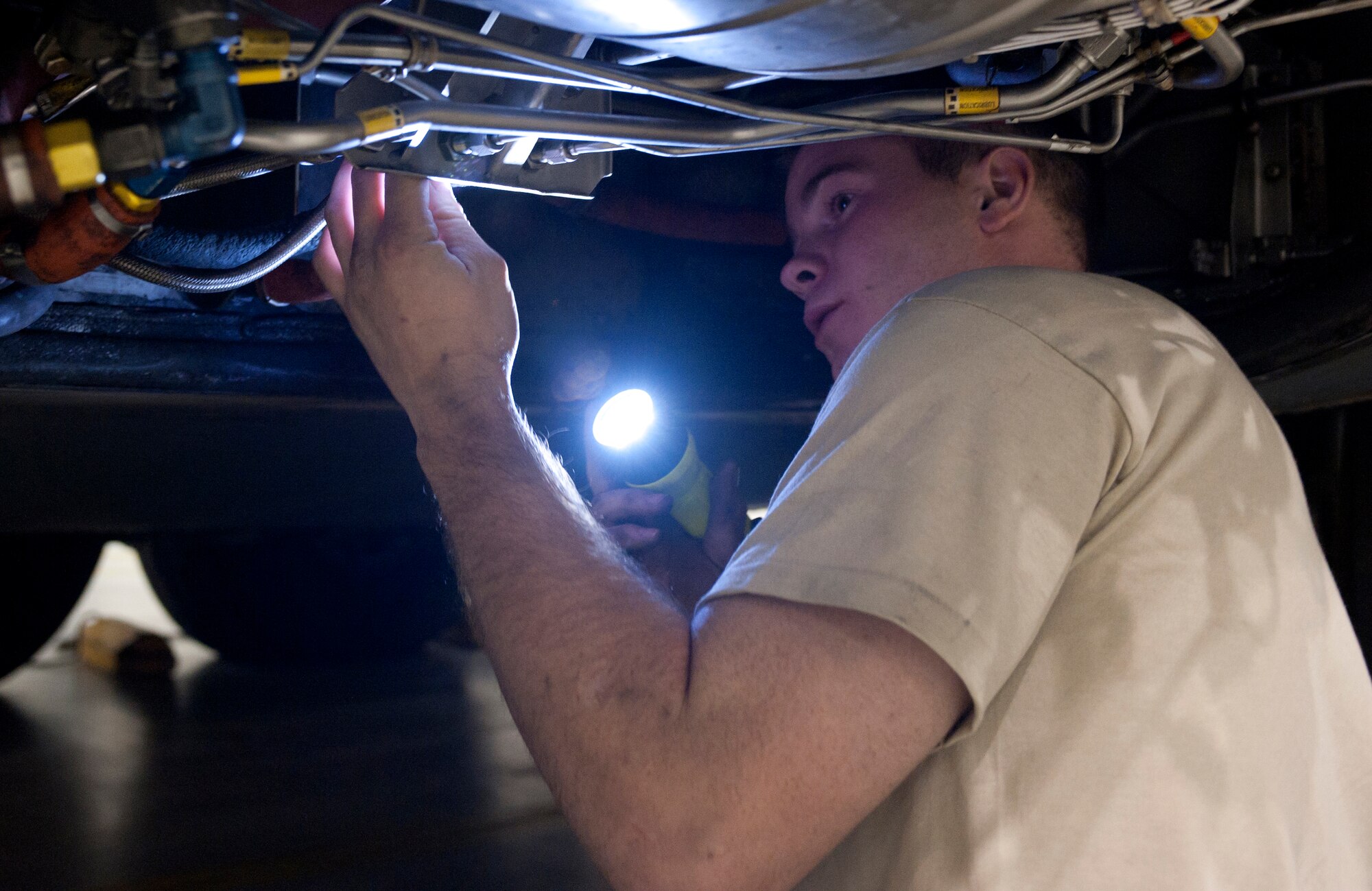 SSgt Brett Clayton, a Crew Chief with the 455th Expeditionary Aircraft Maintenance Squadron from Memphis, TX, checks the landing gear of a U.S. Air Force C-130 Hercules during a comprehensive aircraft inspection at Bagram Airfield, Afghanistan Oct. 17, 2012. The C-130 is a tactical airlift workhorse for coalition forces in Afghanistan, but its mission success depends on the labor of the maintainers who keep the “Herc” ready to fly. (U.S. Air Force Photo/SSgt Jeff Nevison)