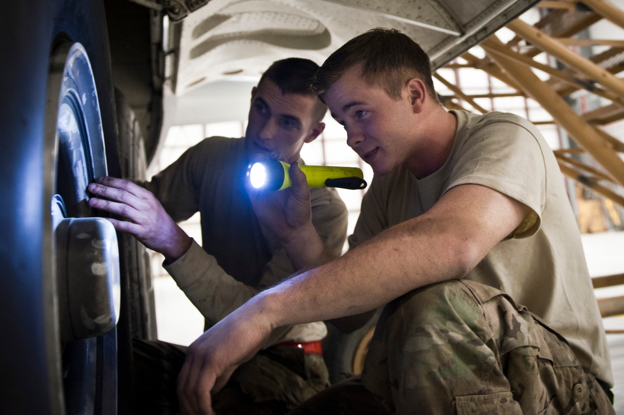 SSgt Brett Clayton, a Crew Chief with the 455th Expeditionary Aircraft Maintenance Squadron from Memphis, TX, checks the landing gear of a U.S. Air Force C-130 Hercules during a comprehensive aircraft inspection at Bagram Airfield, Afghanistan Oct. 17, 2012. The C-130 is a tactical airlift workhorse for coalition forces in Afghanistan, but its mission success depends on the labor of the maintainers who keep the “Herc” ready to fly. (U.S. Air Force Photo/Capt. Raymond Geoffroy)