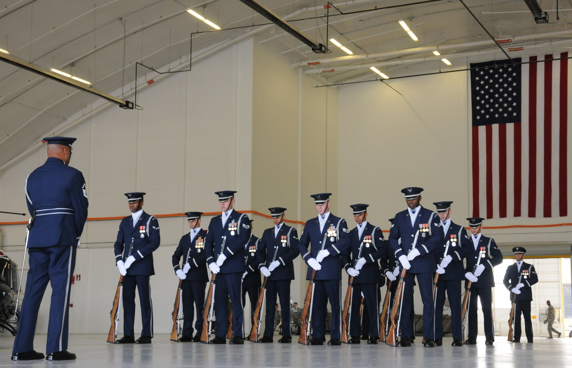 The U.S. Air Force Honor Guard Drill Team prepares for a demonstration to a group from the Embassy of the Federal Republic of Germany, Washington D.C., in Hangar 10 of the 459th Air Refueling Wing, Joint Base Andrews, Md., Oct. 17. The visit included a base tour, demonstrations from the 11th Wing Security Force’s working dog team, The U.S. Air Force Honor Guard Drill Team, The U.S. Air Force Band Max Impact and aircraft displays from the 459th ARW, 1st Helicopter Squadron and the 113th Wing. The German Embassy goes out into the community each year and their visits rotate between the different branches of the embassy. This year, the embassy's military branch had the distinct privilege of hosting. (U.S. Air Force photo/ Senior Airman Katie Spencer)