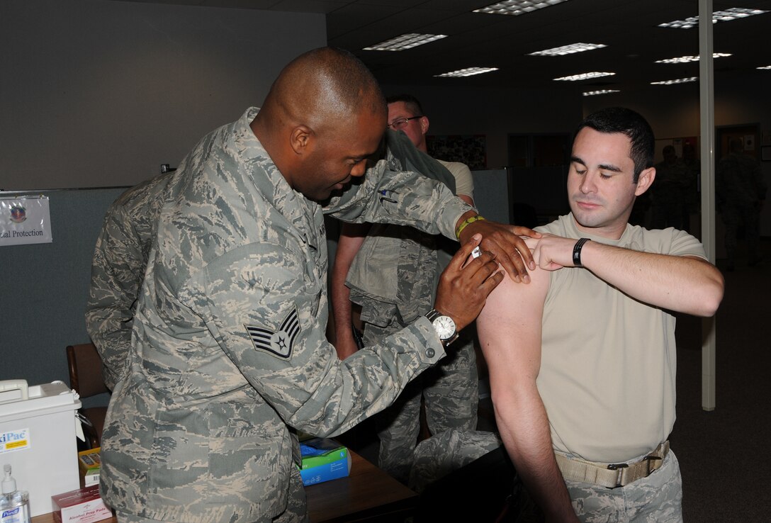 WRIGHT-PATTERSON AIR FORCE BASE, Ohio - Staff Sgt. Jason Thomas, 445th Aerospace Medicine Squadron, administers a flu vaccine to Staff Sgt. Joshua McCrabb, 445th Security Forces Squadron craftsman, during the Oct. 13 unit training assembly for the 2012-13 flu season.  (U.S. Air Force Photo by Tech. Sgt. Anthony G. Springer)