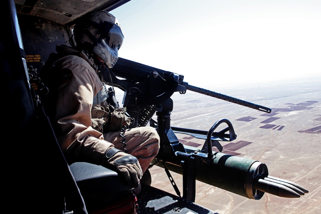 U.S. Marine Corps Staff Sgt. Richard G. Deibler looks out the side door of a UH-1Y Venom utility helicopter during flight operations over Afhanistan's Helmand province, Oct. 17, 2012. Deibler, a door gunner, is assigned to Marine Light Helicopter Squadron 469, Marine Aircraft Group 38, 3rd Marine Aircraft Wing, Forward.