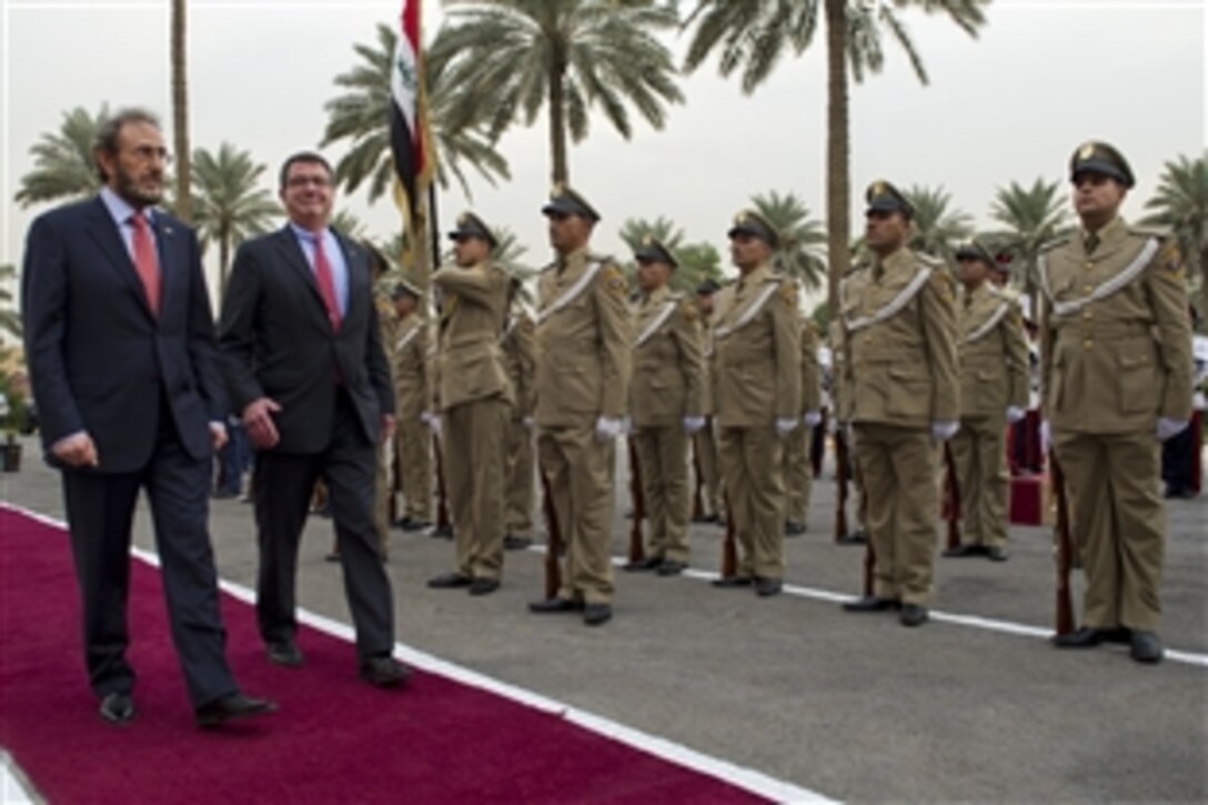 U.S. Deputy Defense Secretary Ashton B. Carter, right, reviews Iraqi troops during a welcoming ceremony hosted by Iraqi Defense Minister Sadun Farhan al-Dulaymi in Baghdad, Oct. 18, 2012. Carter is on a seven-day trip to the Middle East to meet with leaders and counterparts in the region. 