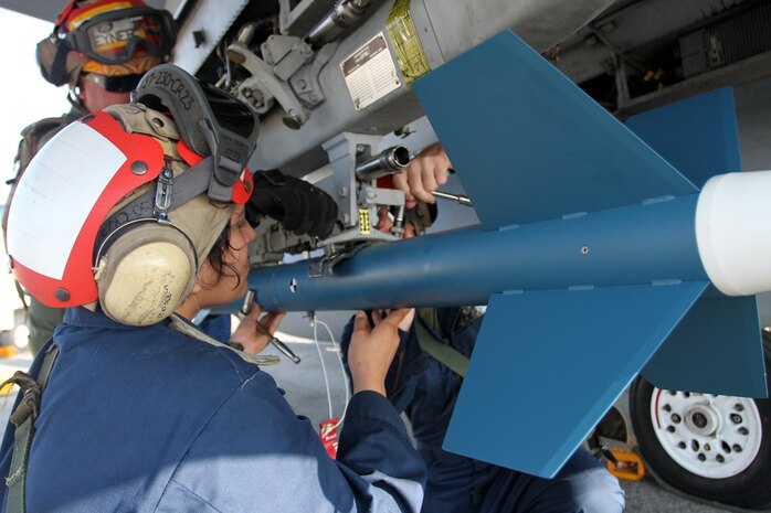 Pfc. Sarah Muniz, Marine All Weather Fighter Attack Squadron 242 ordnance technician, attaches ordnance to an F/A-18D here, in preparation of an air-to-ground exercise in Crow Valley, Philippines, air-to-ground range Oct. 12, 2012. The objective of the exercise was to locate and destroy multiple command and control vehicles within the target area of the Crow Valley range.