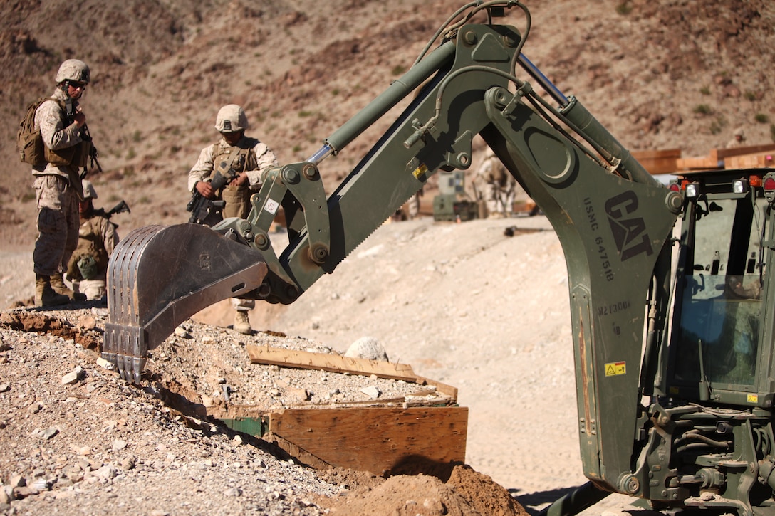 Marines with Alpha Company, 7th Engineer Support Battalion, Combat Logistics Regiment 1, 1st Marine Logistics Group, dig out a bunker at Marine Corps Air Ground Combat Center Twentynine Palms, Calif., Oct. 15. The range improvement was part of a larger battalion-sized exercise, where 7th ESB is training in Twentynine Palms and Camp Pendleton.