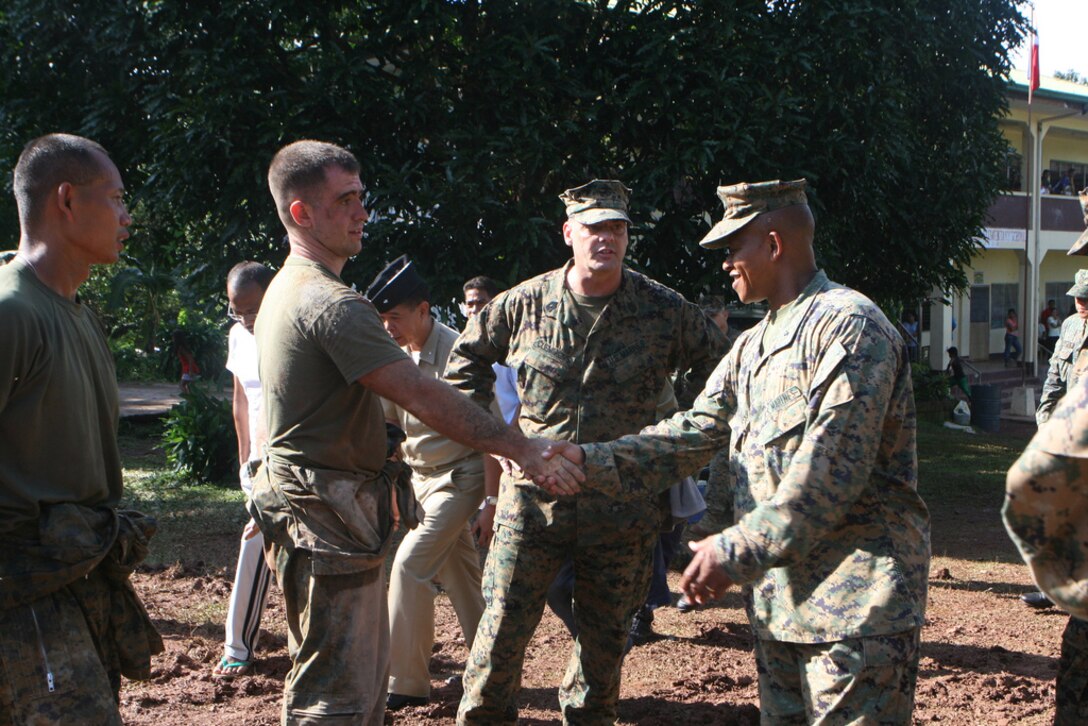 Lance Cpl. Matthew Lehman shakes hands with Brig. Gen. Craig Q. Timberlake Oct 10 during Philippine Bilateral Amphibious Landing Exercise 2013 on the island of Palawan. PHIBLEX 2013 is a bilateral training exercise hosted annually in the Republic of the Philippines to enhance interoperability and readiness of Armed Forces of the Philippines and U.S. Forces. The training is designed to prepare both countries’ military forces for humanitarian service missions as well as strengthen bilateral ties. Projects during the exercise range from the construction of buildings to medical and dental care. Timberlake is the commanding general of the 3rd Marine Expeditionary Brigade and Lehman is a combat engineer with Combat Logistics Battalion 31