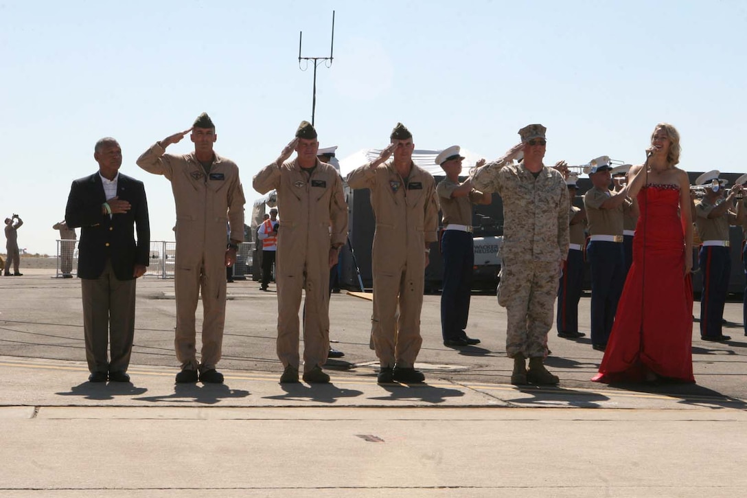 Honored guests salute during the National Anthem at the 2012 Marine Corps Air Station Miramar Air Show, Oct. 13. During the ceremony the station commanding officer and the 3rd MAW commanding general gave speeches followed by a performance from the band.