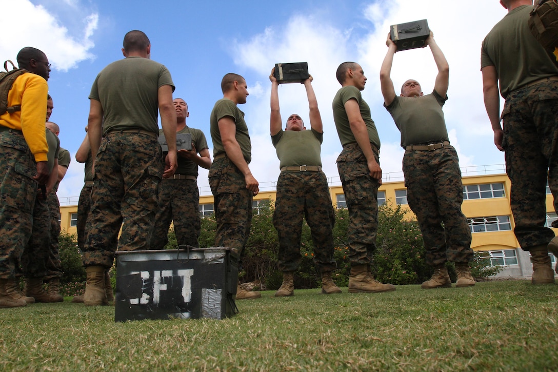 Recruits of Company G, 2nd Recruit Training Battalion, thrust ammunition-cans into the air during their Combat Fitness Test aboard Marine Corps Recruit Depot San Diego Oct. 11. The ammunition-can lifts is one of three portions of the CFT, where recruits must lift a 35-pound ammunition-can fully extending their arms above their head, bringing it back down below their chin.