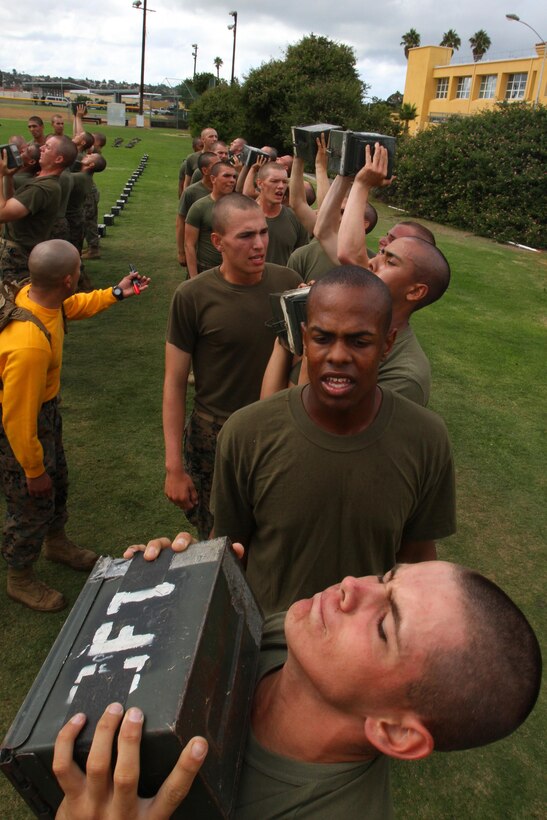 Recruits of Company G, 2nd Recruit Training Battalion, thrust ammunition-cans into the air during their Combat Fitness Test aboard Marine Corps Recruit Depot San Diego Oct. 11. The ammunition-can lifts is one of three portions of the CFT, where recruits must lift a 35-pound ammunition-can fully extending their arms above their head, bringing it back down below their chin.