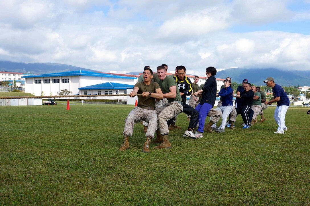 Marines and Japan Ground Self-Defense Force members work together in a tug-of-war match during a fall social at Combined Arms Training Center Camp Fuji Sept. 29. 