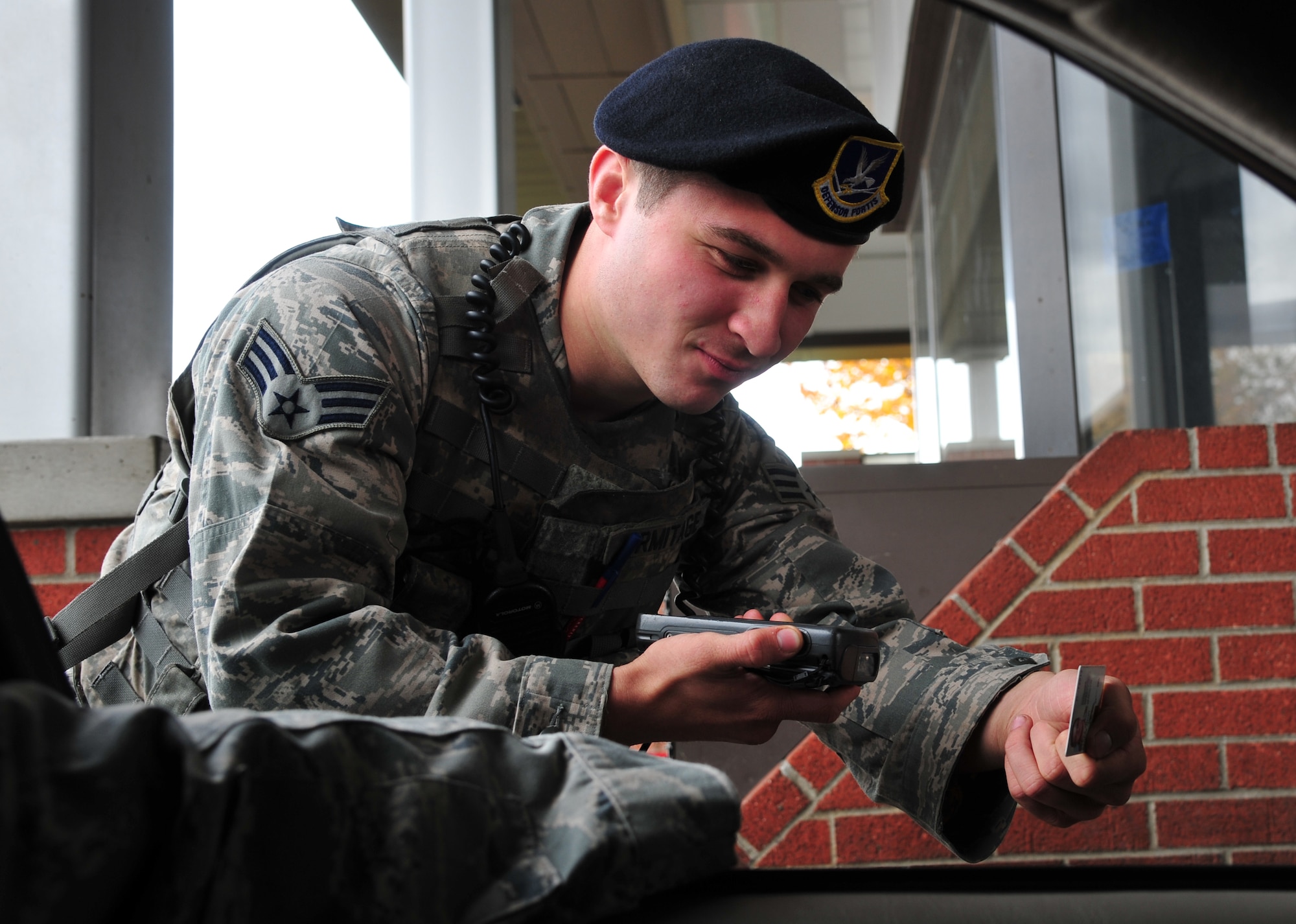 Senior Airman Christopher Armitage checks the common access card of a Fairchild member Oct. 19, 2012 at the main gate. When he’s not working the main gate Wednesday through Saturday, Armitage also does stand-up comedy in downtown Spokane on Monday nights. He is an installation entry controller with the Security Forces Squadron. (U.S. Air Force photo by Airman 1st Class Earlandez Young) 