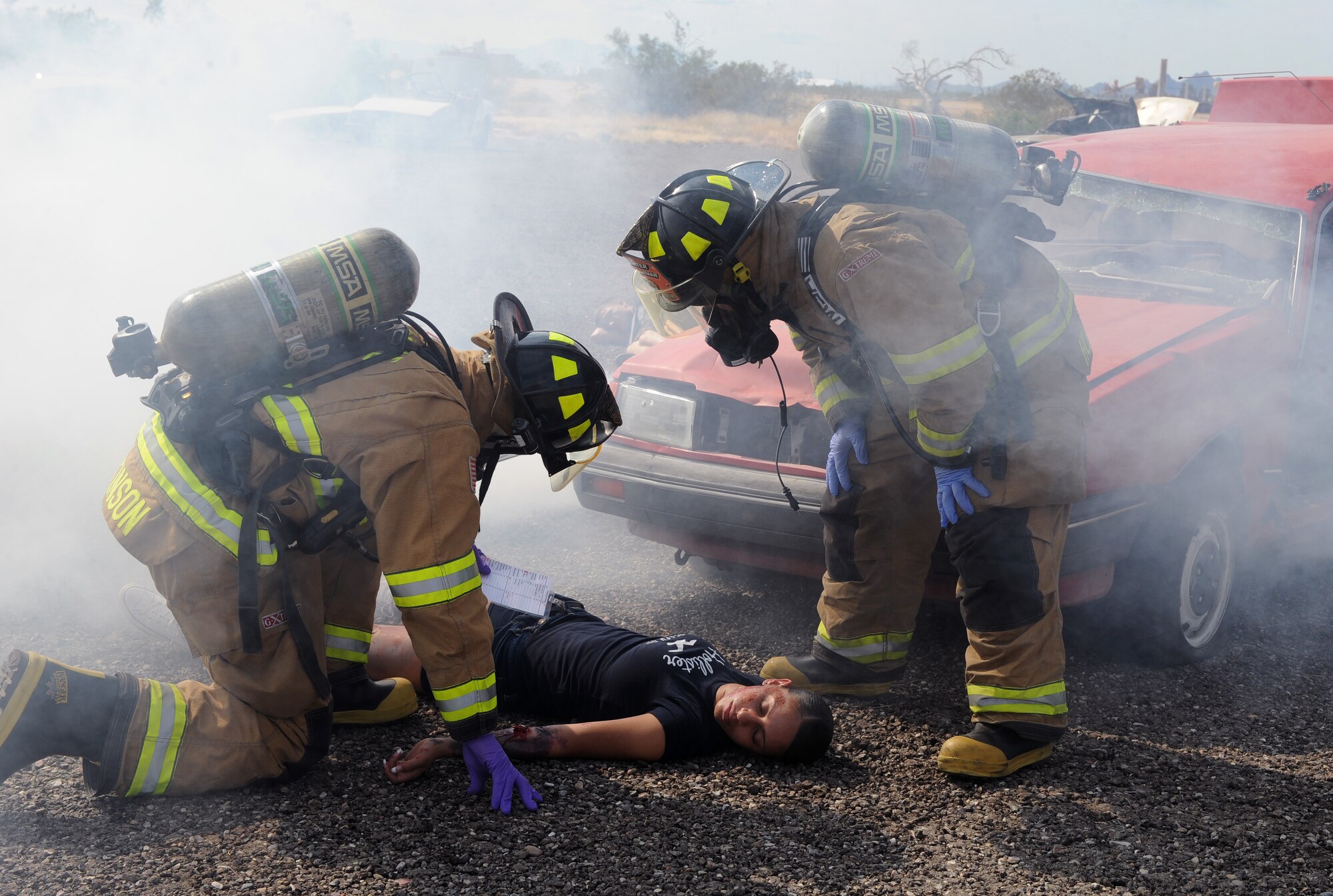 Members of the 355th Civil Engineer Squadron read a card with symptoms of a simulated victim of an explosion during the Response Training and Assessment Program exercise on Davis-Monthan Air Force Base, Oct. 17, 2012. Davis-Monthan is one of three instillations needed to validate the RTAP training and exercise program to meet the requirements for Headquarters Air Force. (U.S. Air Force photo by Senior Airman Brittany Dowdle/release)