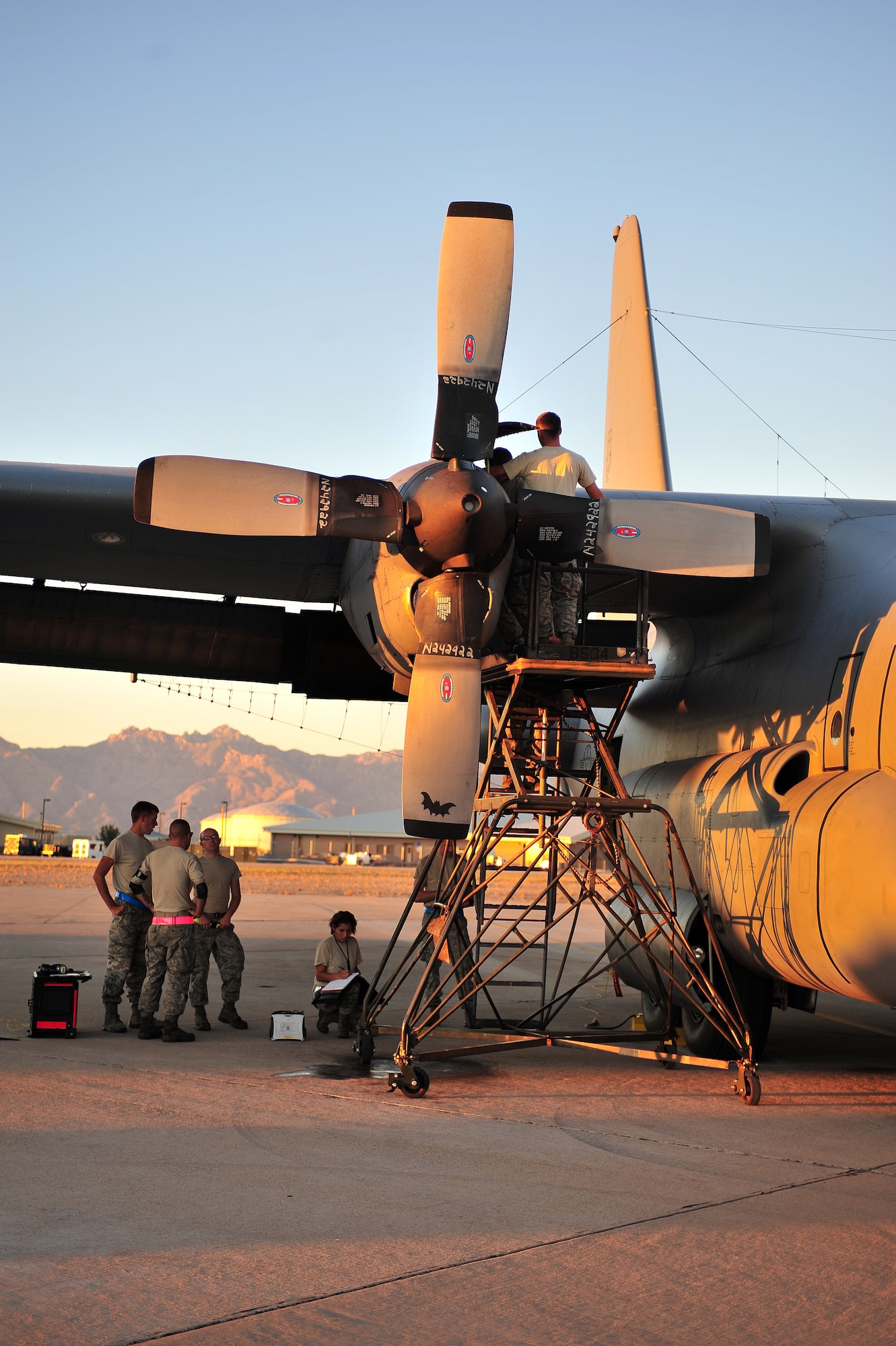 U.S. Air Force Airmen from the 755th Aircraft Maintenance Squadron, work together to fix the EC-130H engine on Davis-Monthan Air Force Base, Ariz., Oct. 15, 2012. The Airmen from the 755th AMXS are part of the 55th Electronic Combat Group. (U.S. Air Force photo by Airman 1st Class Josh Slavin/Released)