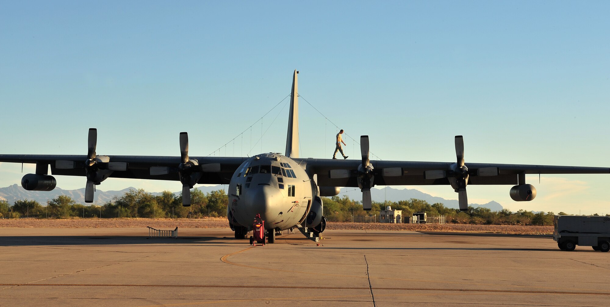 A U.S. Air Force Airman from the 755th Aircraft Maintenance Squadron walks on the wing of an EC-130H on Davis-Monthan Air-Force Base, Ariz., Oct. 15, 2012. The 755th AMXS plans and executes all on-equipment maintenance actions for 14 EC-130H and one TC-130H aircraft, including launch and recovery, scheduled inspections, servicing and component replacement. (U.S. Air Force photo by Airman 1st Class Josh Slavin/Released)