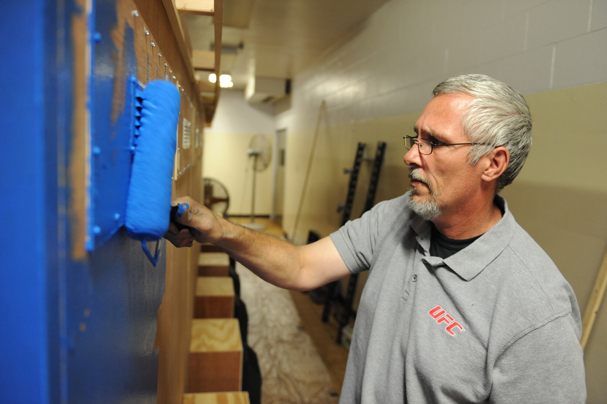 Tony Flowers, 2nd Force Support Squadron Barksdale Club general manager, paints a custom built entertainment center for the upcoming Game-Tastic Fest in the Stripes Club on Barksdale Air Force Base, La., Oct. 19. Game-Tastic Fest is a two-day video game competition that will feature Halo 4 and Call of Duty Black Ops 2. Two competitions will be held, one for youths ages eight to 17 years old and one for adults 18 years and up. (U.S. Air Force photo/Senior Airman Micaiah Anthony)(RELEASED)
