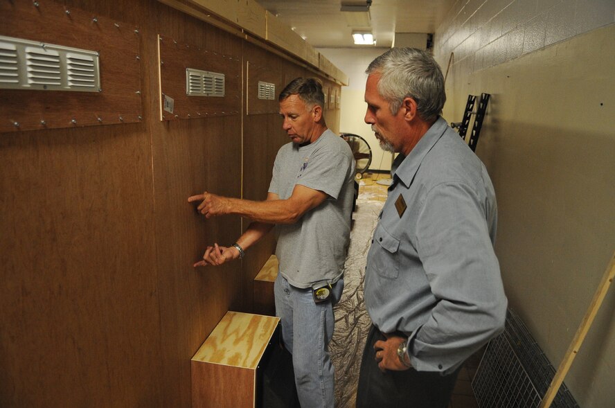 Mark Huffman, 2nd Force Support Squadron engineering technician shows Tony Flowers, 2 FSS Barksdale Club general manager, where T.V.s will go on a custom built entertainment center in the Stripes Club on Barksdale Air Force Base, La., Oct. 17. The 25-foot entertainment center was built by hand for a gaming tournament called Game-Tastic Fest. The entertainment center will house 16 Xbox 360s and 32-inch televisions. The winning team will receive $300, with second and third place teams taking home $200 and $100, respectively. (U.S. Air Force photo/Senior Airman Micaiah Anthony)(RELEASED)