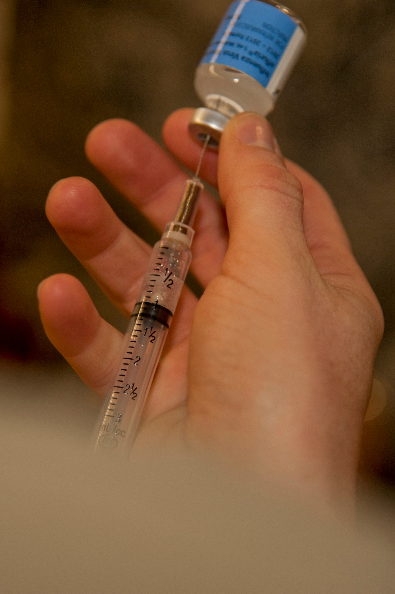 VANDENBERG AIR FORCE BASE, Calif. – A syringe is filled with influenza vaccine at the Point of Distribution (POD) in the Installation Deployment Readiness Cell here Thursday, Oct. 18, 2012.  Active duty Airmen reported to the POD in an exercise simulating mass immunization against anthrax, and base authorities used the opportunity to distribute this year’s real world influenza vaccine.  The POD distributed Skittles candy representing the anthrax prophylaxis to over 1,900 Airmen and then vaccinated over 1,500 Airmen for influenza, raising the wing’s flu vaccination rate to over 90%.  The purpose of the exercise was toevaluate the wing’s response to a public health emergency by testing the 30th Medical Group’s ability to stand up a POD and rapidly distribute countermeasures. Mass inoculation of this scale was a first for Vandenberg Air Force Base. (U.S. Air Force photo/Senior Airman Lael Huss)